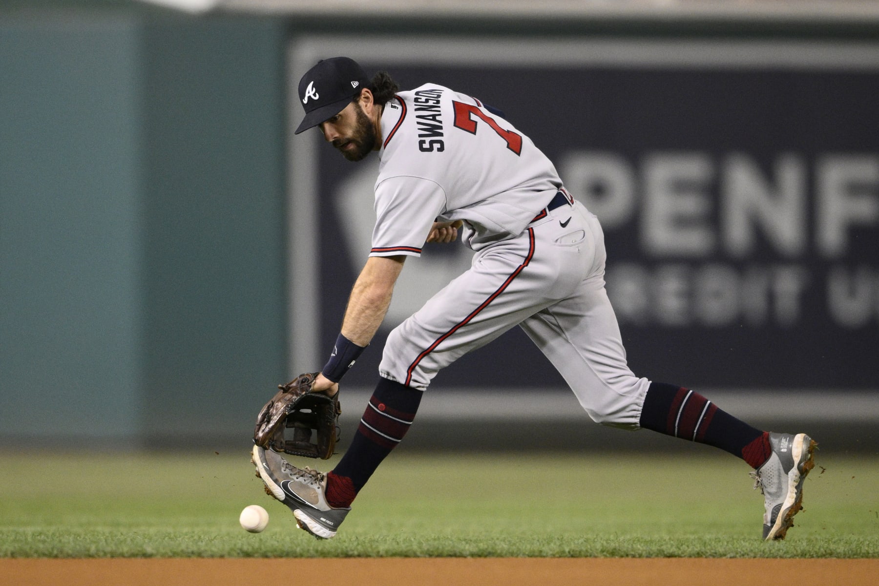 Atlanta Braves shortstop Dansby Swanson chases a ball that went for a single by Washington Nationals' CJ Abrams during the first inning of a baseball game Wednesday, Sept. 28, 2022, in Washington. (AP Photo/Nick Wass)