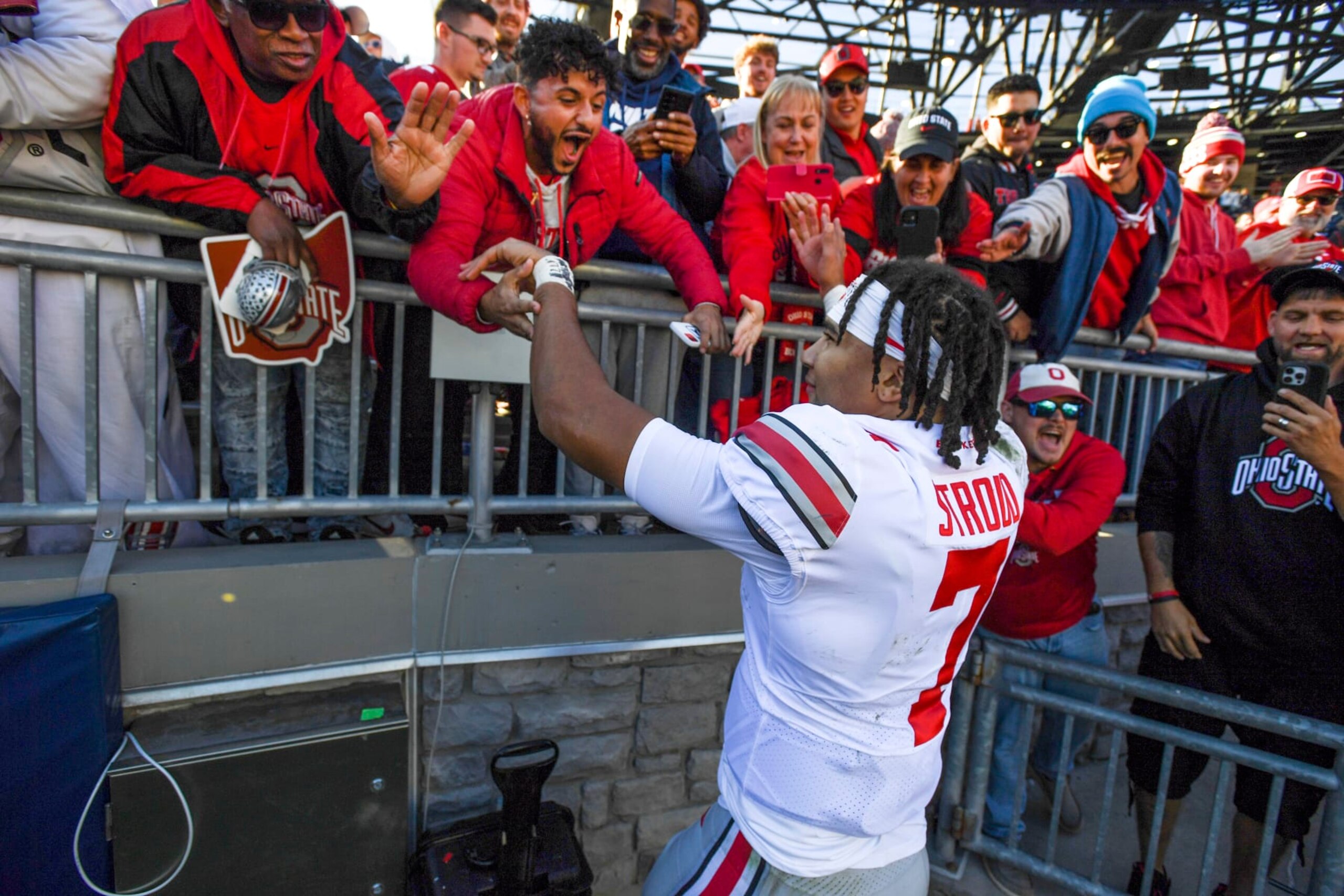 Ohio State quarterback C.J. Stroud (7) celebrates with fans after defeating Penn State 44-31 in an NCAA college football game, Saturday, Oct. 29, 2022, in State College, Pa. (AP Photo/Barry Reeger)