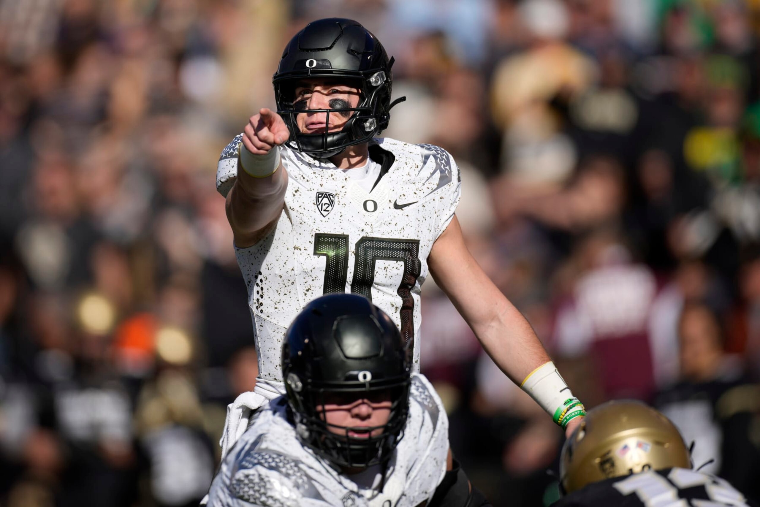 Oregon quarterback Bo Nix directs players at the line of scrimmage against Colorado in the first half of an NCAA college football game, Saturday, Nov. 5, 2022, in Boulder, Colo. (AP Photo/David Zalubowski)