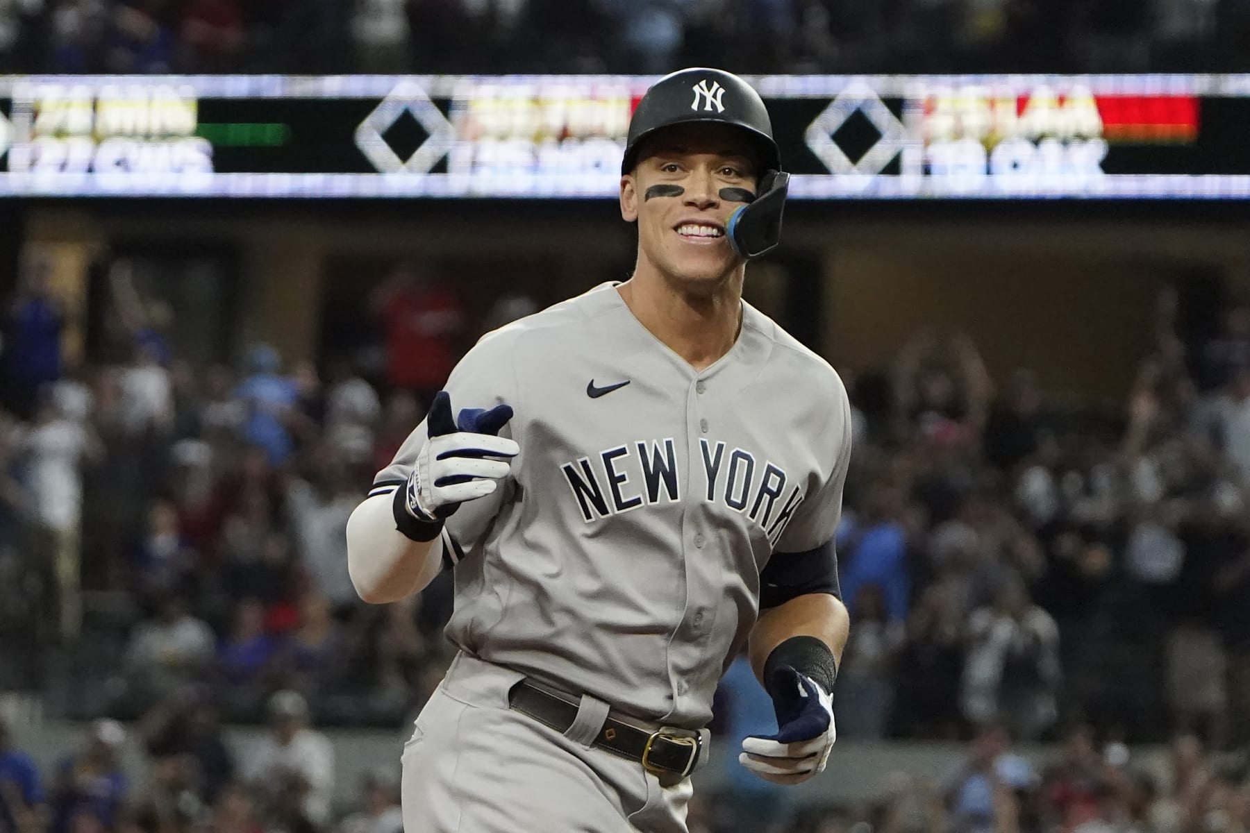 New York Yankees' Aaron Judge gestures as he rounds the bases after hitting a solo home run, his 62nd of the season, during the first inning in the second baseball game of a doubleheader against the Texas Rangers in Arlington, Texas, Tuesday, Oct. 4, 2022. With the home run, Judge set the AL record for home runs in a season, passing Roger Maris. (AP Photo/LM Otero)