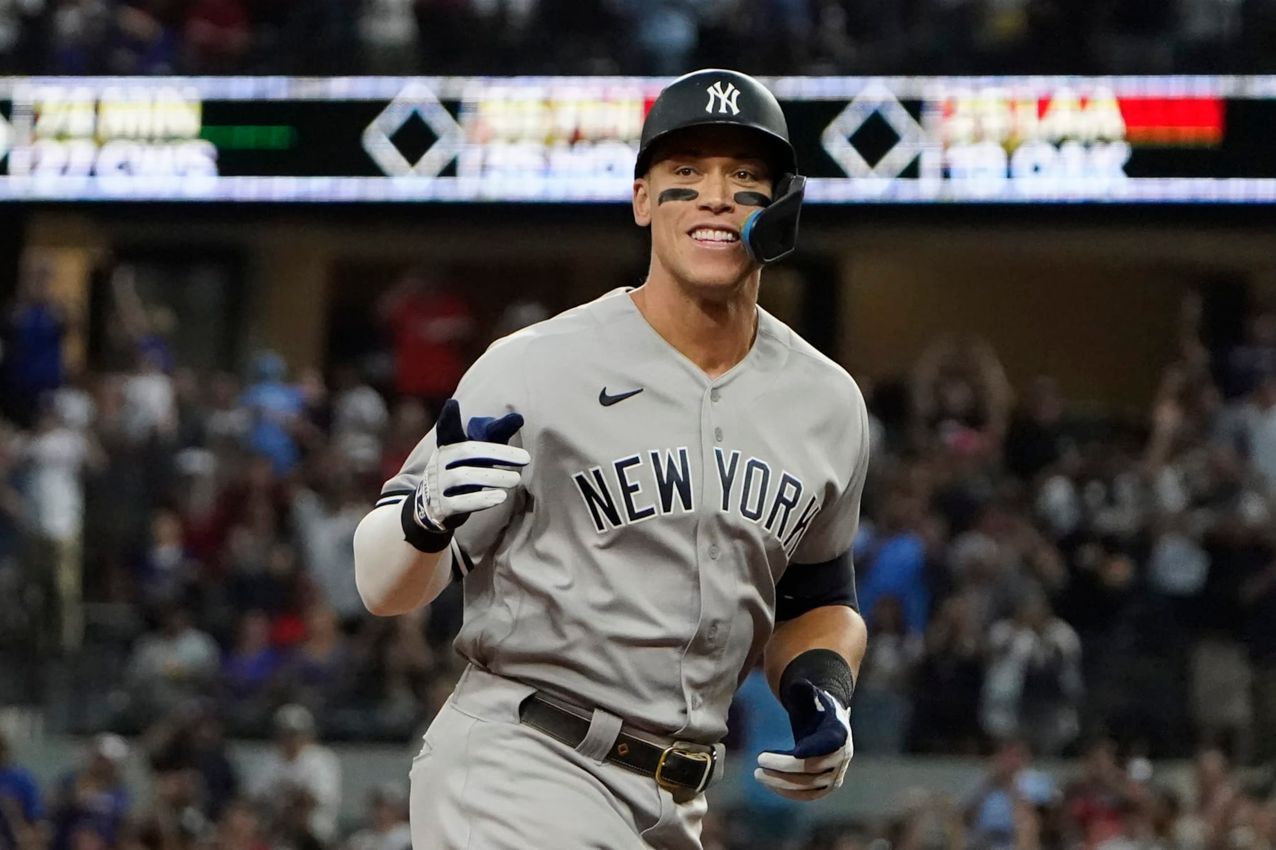 New York Yankees' Aaron Judge gestures as he rounds the bases after hitting a solo home run, his 62nd of the season, during the first inning in the second baseball game of a doubleheader against the Texas Rangers in Arlington, Texas, Tuesday, Oct. 4, 2022. With the home run, Judge set the AL record for home runs in a season, passing Roger Maris. (AP Photo/LM Otero) New York Yankees' Aaron Judge gestures as he rounds the bases after hitting a solo home run, his 62nd of the season, during the first inning in the second baseball game of a doubleheader against the Texas Rangers in Arlington, Texas, Tuesday, Oct. 4, 2022. With the home run, Judge set the AL record for home runs in a season, passing Roger Maris. (AP Photo/LM Otero)