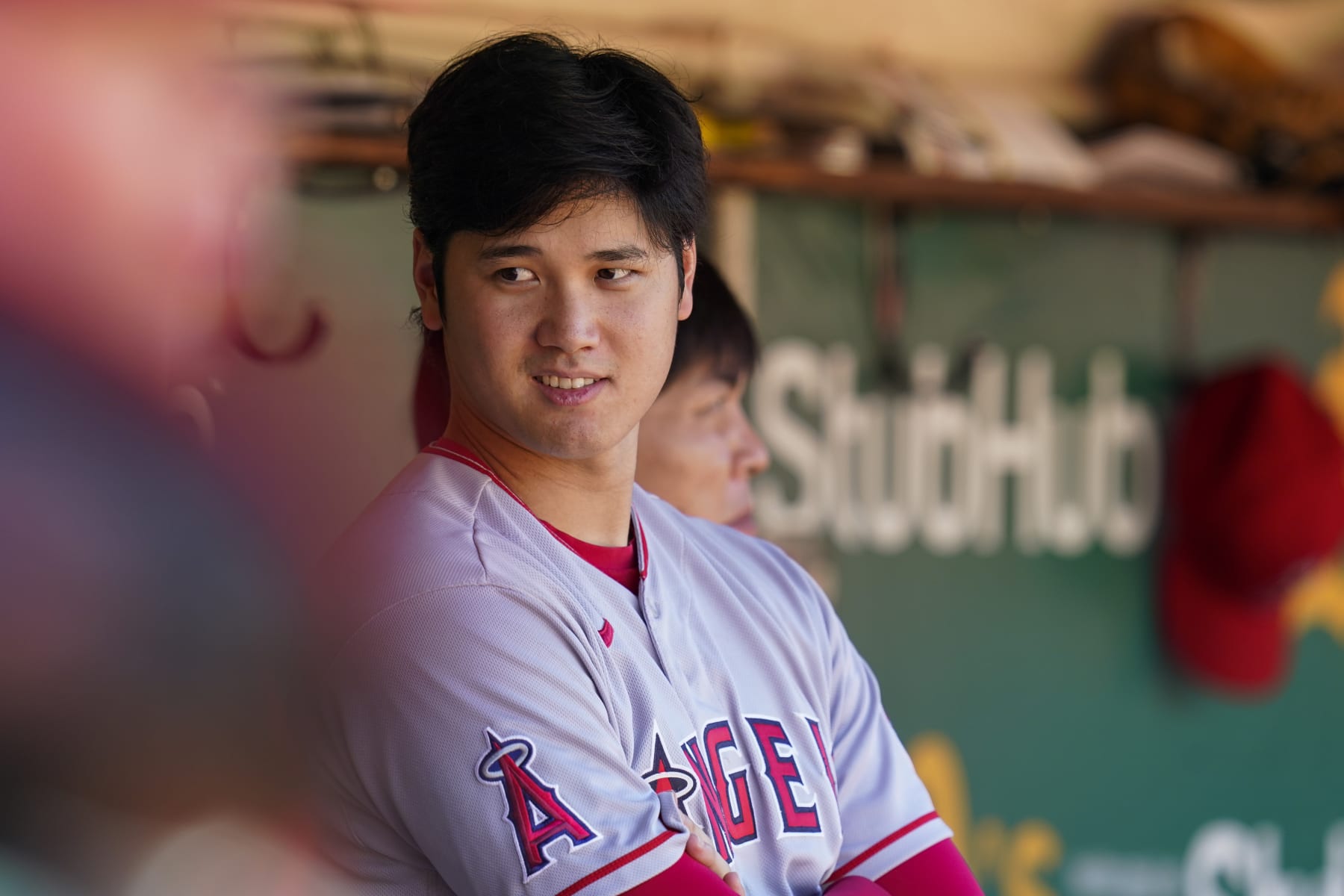 Los Angeles Angels' Shohei Ohtani stands in the dugout during the seventh inning of a baseball game against the Oakland Athletics in Oakland, Calif., Wednesday, Oct. 5, 2022. (AP Photo/Godofredo A. Vásquez)