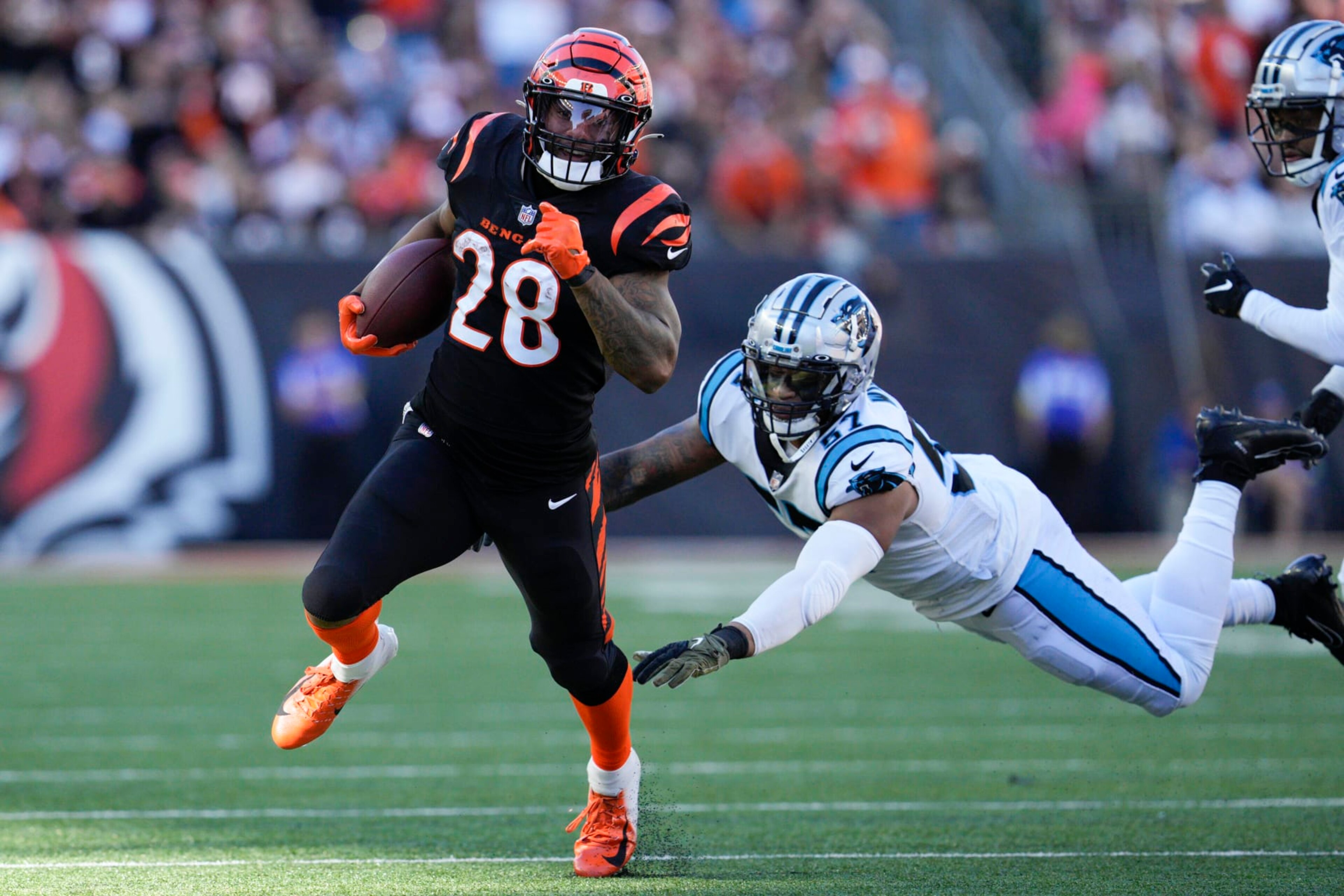 Cincinnati Bengals running back Joe Mixon (28) runs past Carolina Panthers linebacker Damien Wilson (57) during the first half of an NFL football game, Sunday, Nov. 6, 2022, in Cincinnati. (AP Photo/Jeff Dean) Cincinnati Bengals running back Joe Mixon (28) runs past Carolina Panthers linebacker Damien Wilson (57) during the first half of an NFL football game, Sunday, Nov. 6, 2022, in Cincinnati. (AP Photo/Jeff Dean)