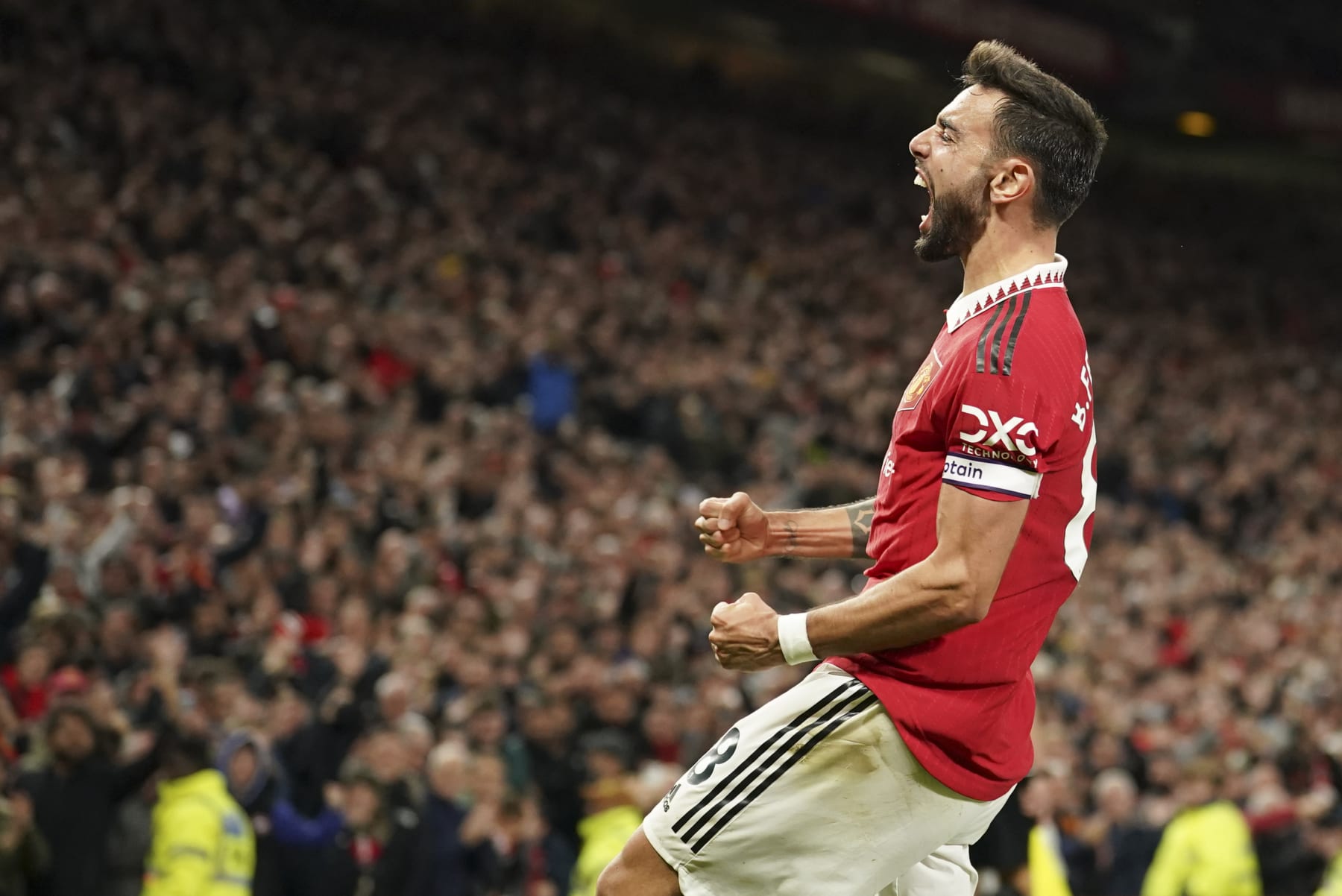 Manchester United's Bruno Fernandes celebrates after scoring his team's second goal during the English Premier League soccer match between Manchester United and Tottenham Hotspur at Old Trafford in Manchester, England, Wednesday, Oct. 19, 2022. (AP Photo/Dave Thompson)