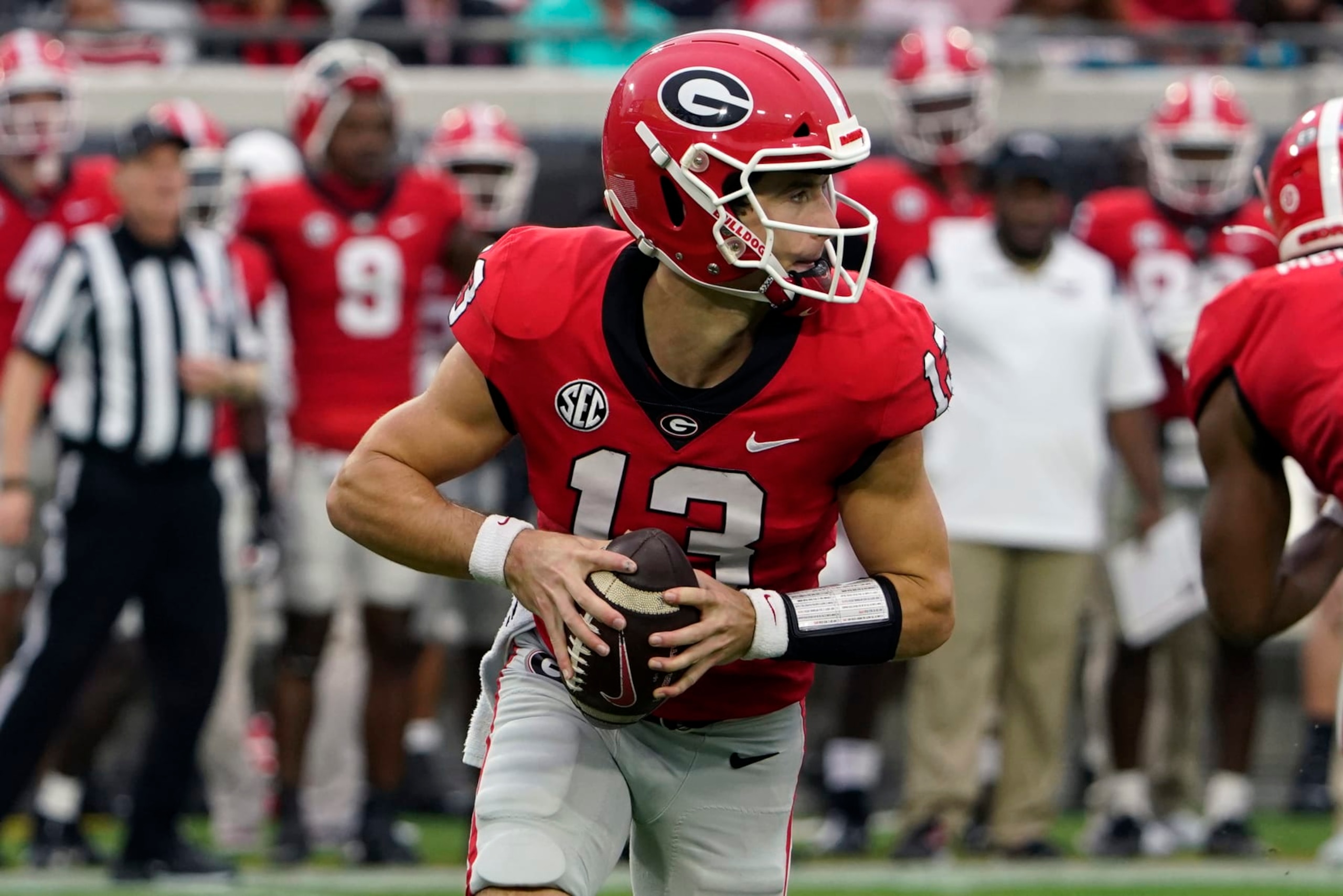 Georgia quarterback Stetson Bennett (13) scrambles as he looks for a receiver against Florida during the first half of an NCAA college football game, Saturday, Oct. 29, 2022, in Jacksonville, Fla. (AP Photo/John Raoux) Georgia quarterback Stetson Bennett (13) scrambles as he looks for a receiver against Florida during the first half of an NCAA college football game, Saturday, Oct. 29, 2022, in Jacksonville, Fla. (AP Photo/John Raoux)