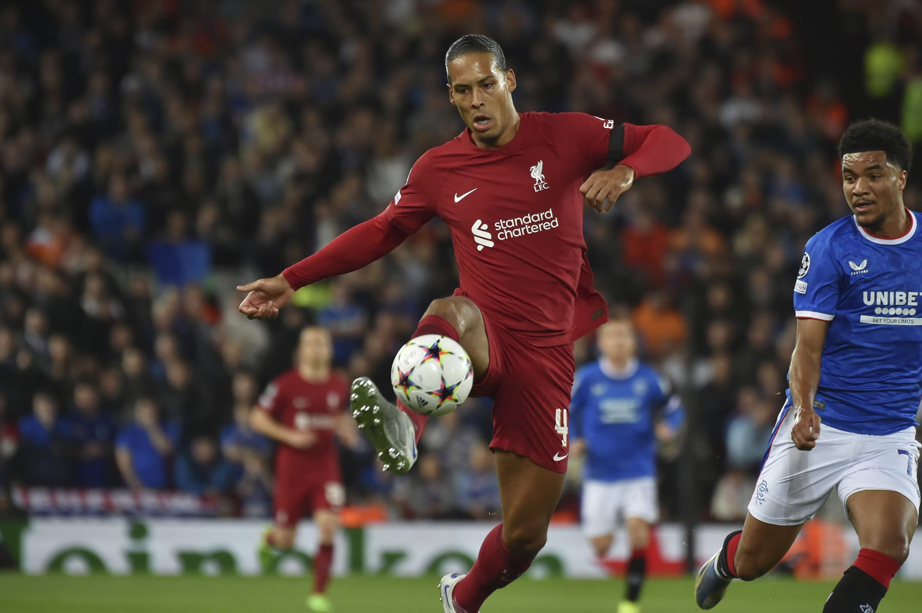 Liverpool's Virgil van Dijk, centre, controls the ball during the Champions League Group A soccer match between Liverpool and Rangers at Anfield stadium in Liverpool, England, Tuesday Oct. 4, 2022. (AP Photo/Rui Vieira)