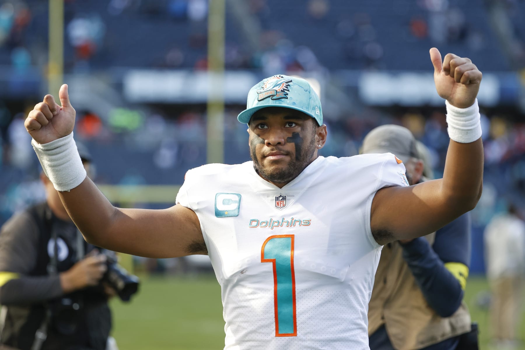 Miami Dolphins quarterback Tua Tagovailoa (1) celebrates as he walks off the field after an NFL football game against the Chicago Bears, Sunday, Nov. 6, 2022, in Chicago. (AP Photo/Kamil Krzaczynski)