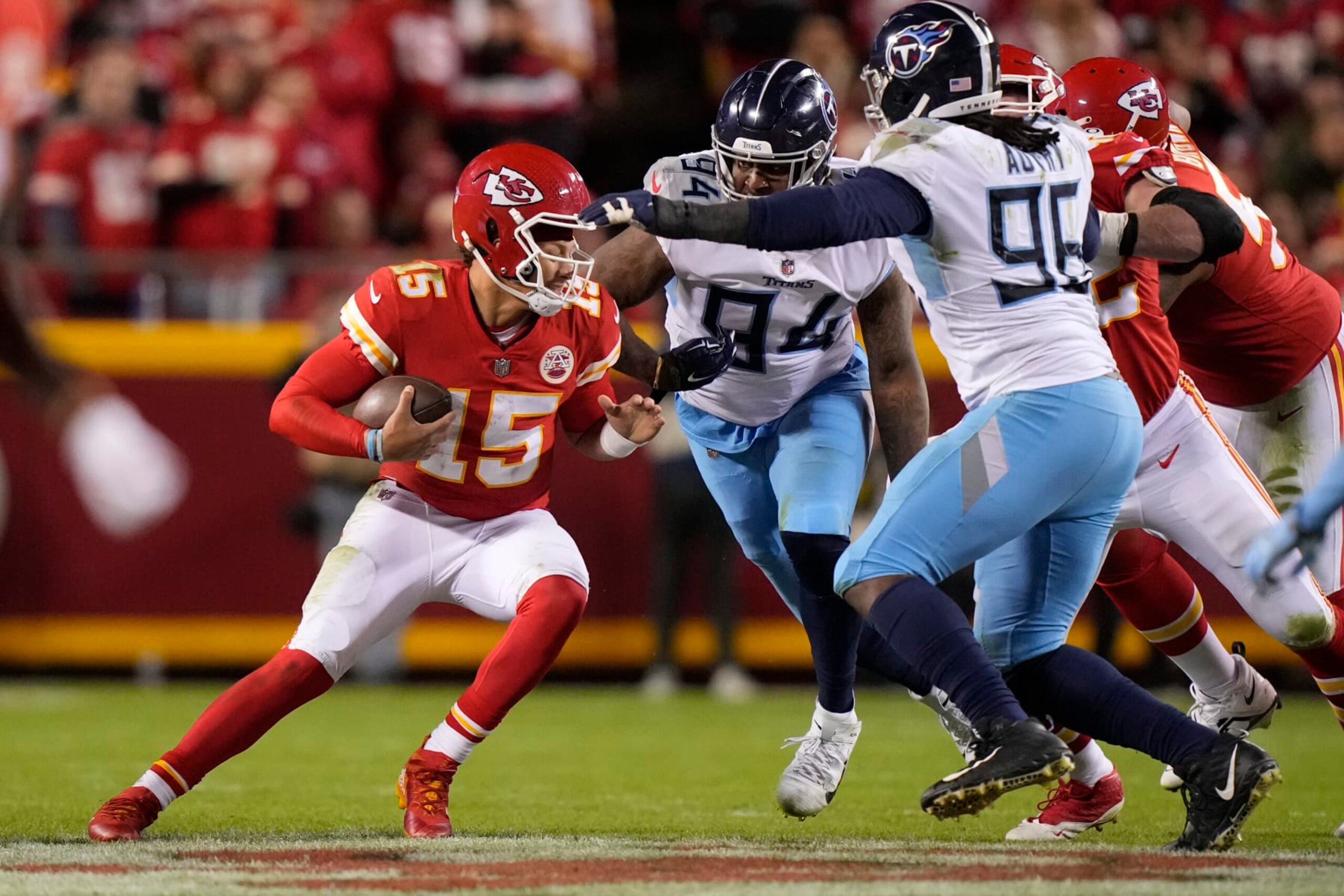 Kansas City Chiefs quarterback Patrick Mahomes (15) is sacked by Tennessee Titans defensive end Mario Edwards Jr. (94) as defensive end Denico Autry (96) defends during the second half of an NFL football game Sunday, Nov. 6, 2022, in Kansas City, Mo. (AP Photo/Charlie Riedel)