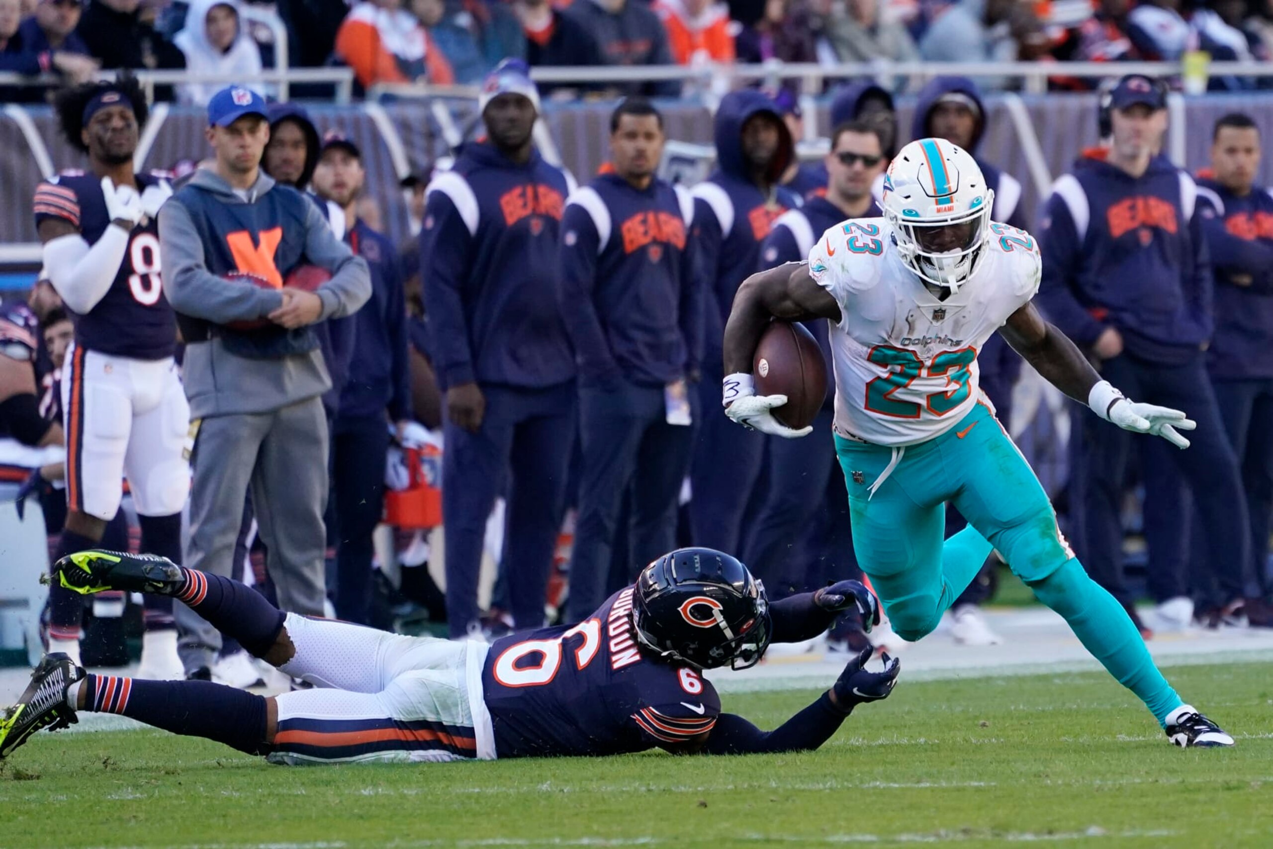 Miami Dolphins running back Jeff Wilson Jr. (23) avoids a tackle by Chicago Bears defensive back Kyler Gordon (6) during the second half of an NFL football game, Sunday, Nov. 6, 2022 in Chicago. (AP Photo/Charles Rex Arbogast) Miami Dolphins running back Jeff Wilson Jr. (23) avoids a tackle by Chicago Bears defensive back Kyler Gordon (6) during the second half of an NFL football game, Sunday, Nov. 6, 2022 in Chicago. (AP Photo/Charles Rex Arbogast)