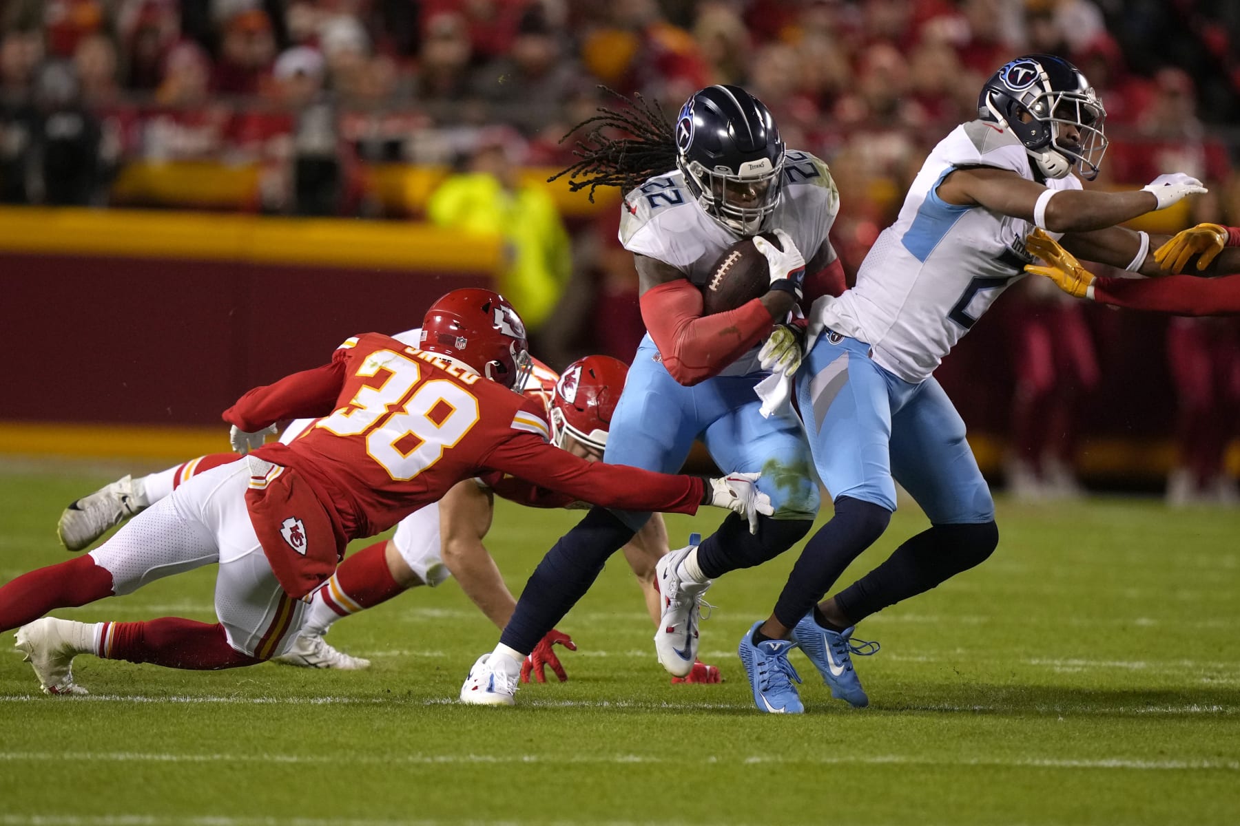 Tennessee Titans running back Derrick Henry (22) runs with the ball ;past Kansas City Chiefs cornerback L'Jarius Sneed (38) during the first half of an NFL football game Sunday, Nov. 6, 2022, in Kansas City, Mo. (AP Photo/Charlie Riedel)
