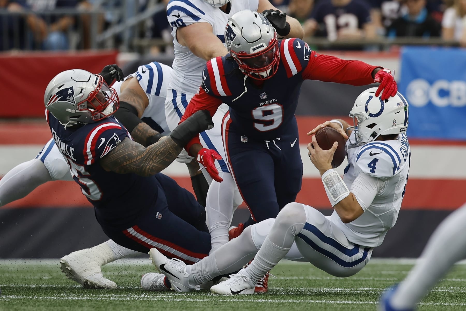 New England Patriots defensive tackle Daniel Ekuale (95) and linebacker Matthew Judon (9) sack Indianapolis Colts quarterback Sam Ehlinger (4) in the first half of an NFL football game, Sunday, Nov. 6, 2022, in Foxborough, Mass. (AP Photo/Michael Dwyer)