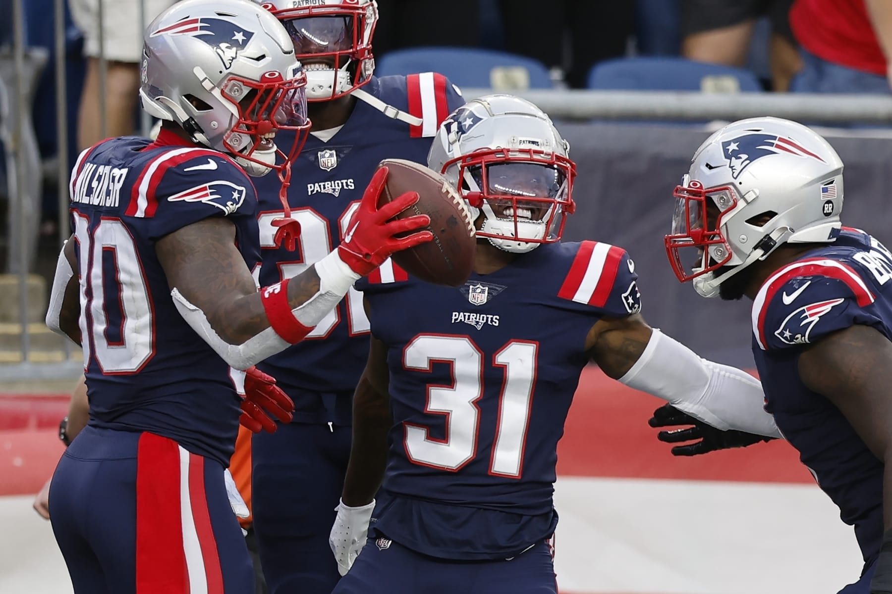 New England Patriots cornerback Jonathan Jones (31) celebrates with teammates in the second half of an NFL football game against the Indianapolis Colts, Sunday, Nov. 6, 2022, in Foxborough, Mass. (AP Photo/Michael Dwyer)