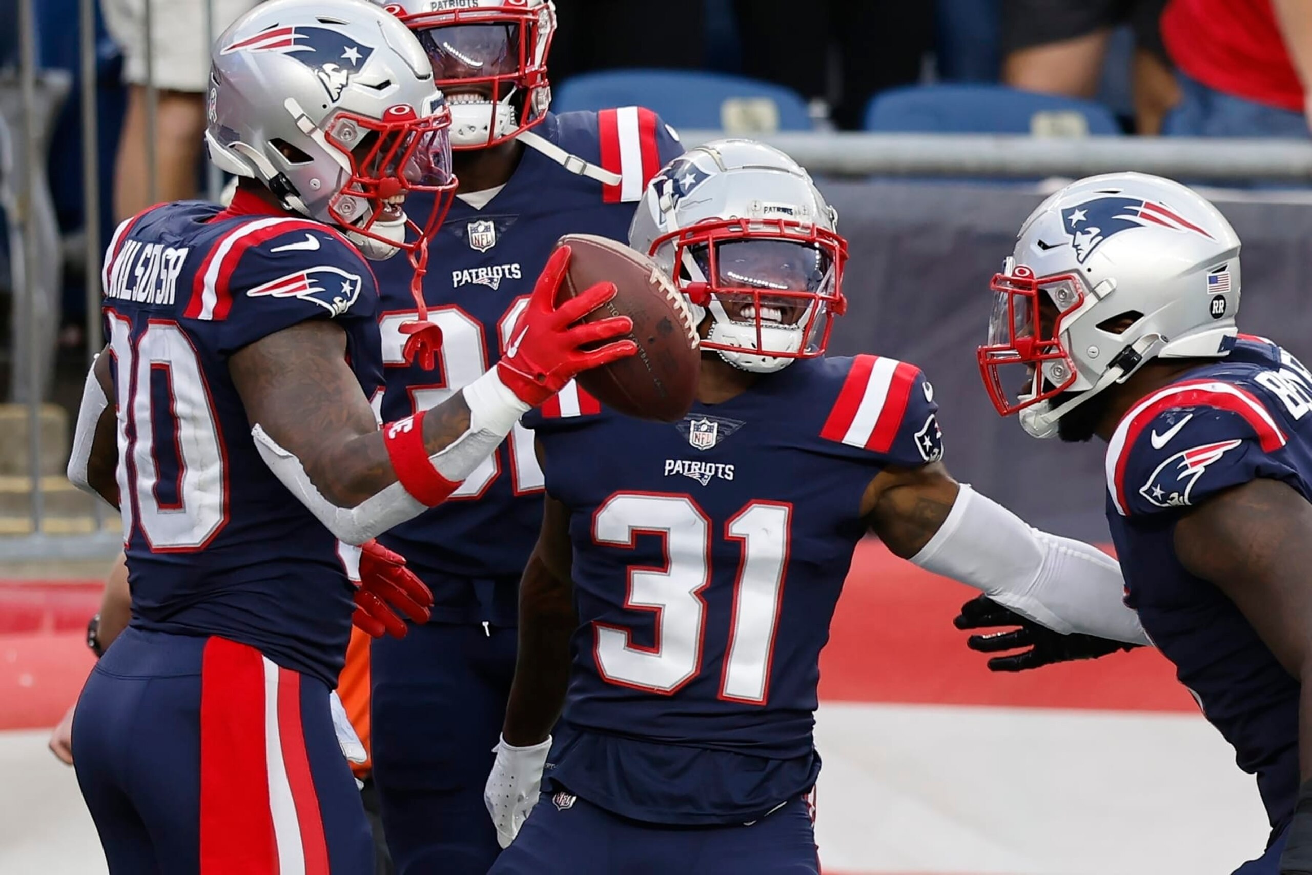 New England Patriots cornerback Jonathan Jones (31) celebrates with teammates in the second half of an NFL football game against the Indianapolis Colts, Sunday, Nov. 6, 2022, in Foxborough, Mass. (AP Photo/Michael Dwyer) New England Patriots cornerback Jonathan Jones (31) celebrates with teammates in the second half of an NFL football game against the Indianapolis Colts, Sunday, Nov. 6, 2022, in Foxborough, Mass. (AP Photo/Michael Dwyer)