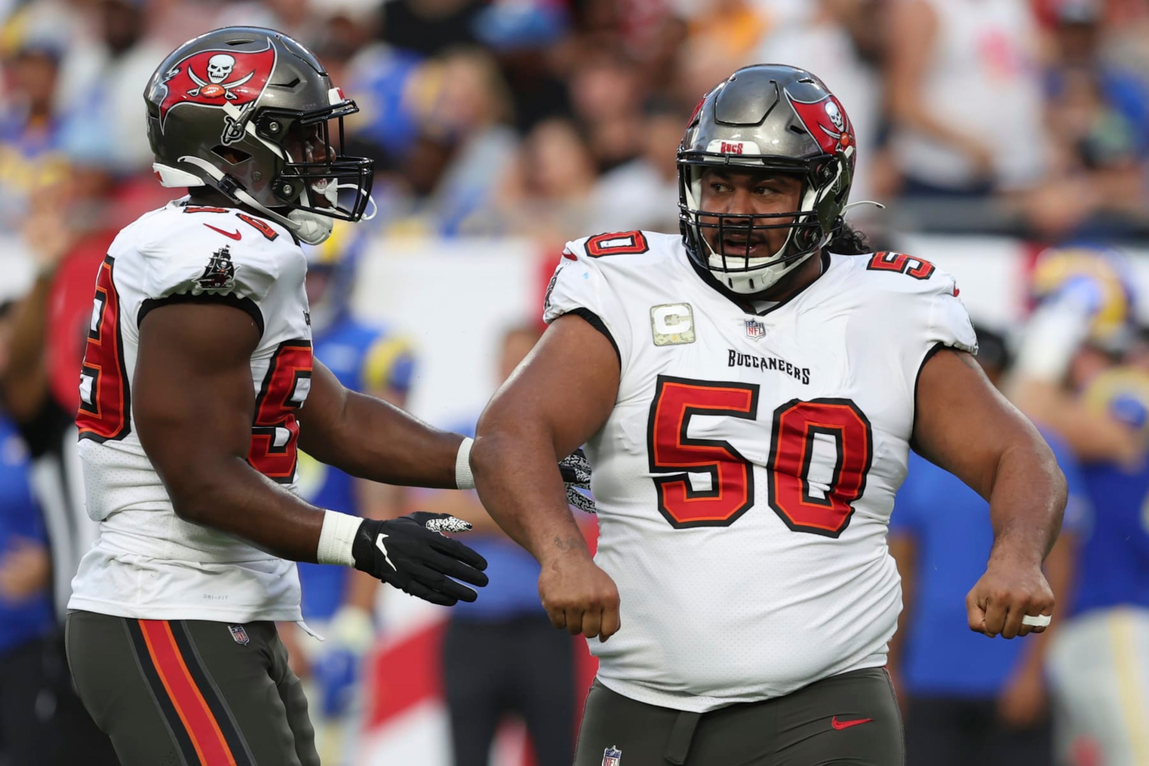 Tampa Bay Buccaneers defensive tackle Vita Vea (50) celebrates with teammate Justin Hollins after sacking Los Angeles Rams quarterback Matthew Stafford during the first half of an NFL football game between the Los Angeles Rams and Tampa Bay Buccaneers, Sunday, Nov. 6, 2022, in Tampa, Fla. (AP Photo/Mark LoMoglio) Tampa Bay Buccaneers defensive tackle Vita Vea (50) celebrates with teammate Justin Hollins after sacking Los Angeles Rams quarterback Matthew Stafford during the first half of an NFL football game between the Los Angeles Rams and Tampa Bay Buccaneers, Sunday, Nov. 6, 2022, in Tampa, Fla. (AP Photo/Mark LoMoglio)