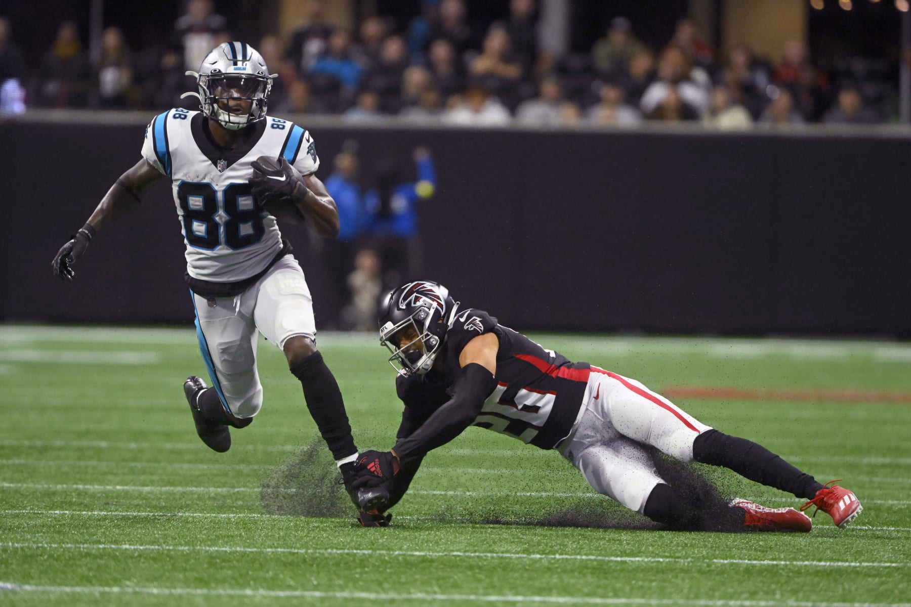 Carolina Panthers wide receiver Terrace Marshall Jr. (88) runs with the ball as Atlanta Falcons cornerback Isaiah Oliver (26) defends during the second half of an NFL football game Sunday, Oct. 30, 2022, in Atlanta. (AP Photo/John Amis)
