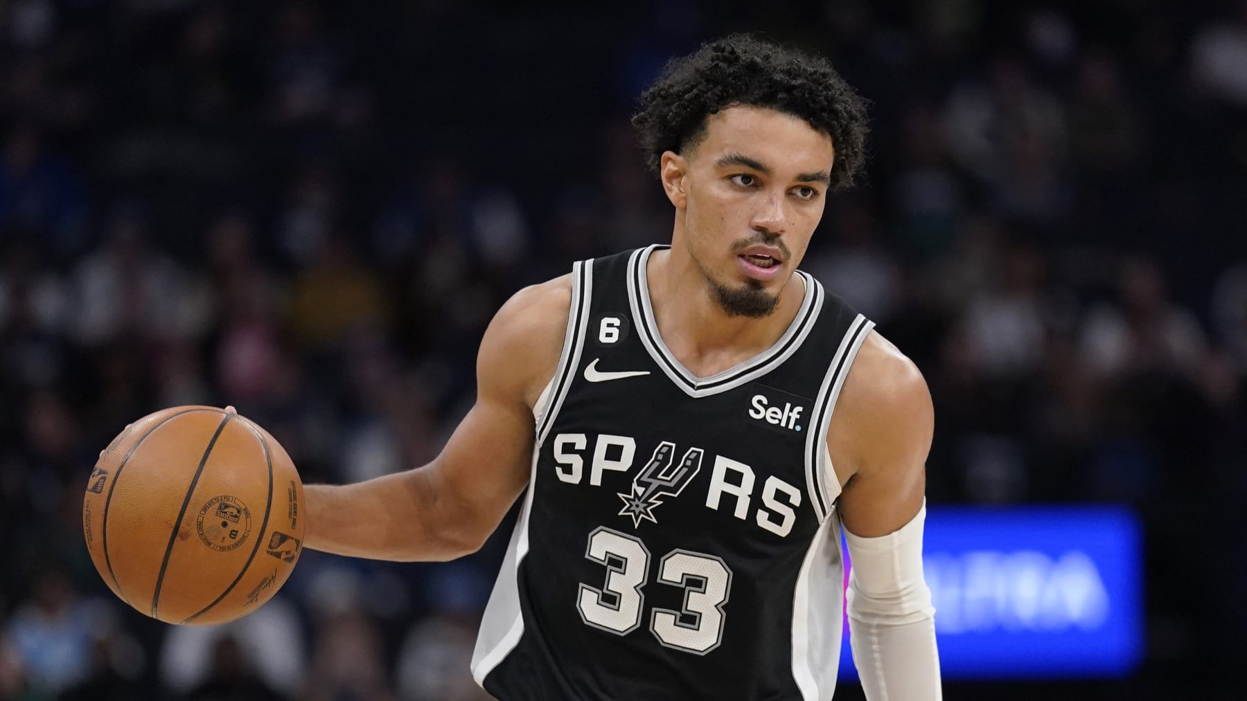 San Antonio Spurs guard Tre Jones (33) dribbles down the court during the second half of an NBA basketball game against the Minnesota Timberwolves, Monday, Oct. 24, 2022, in Minneapolis. (AP Photo/Abbie Parr)