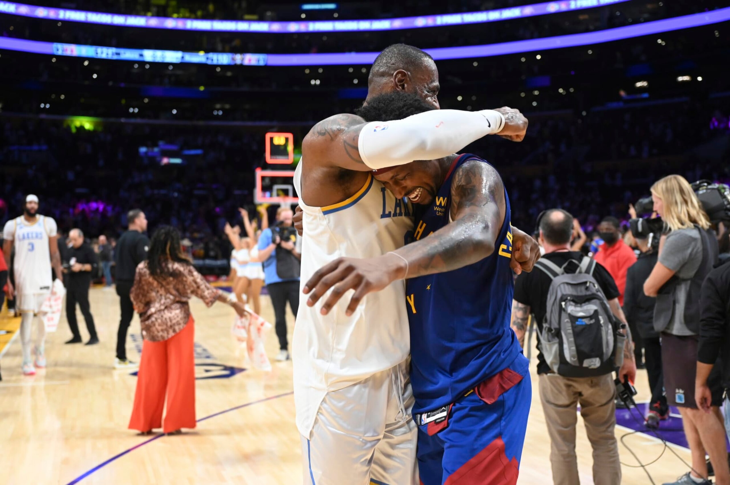 Los Angeles Lakers forward LeBron James, left, hugs Denver Nuggets guard Kentavious Caldwell-Pope (5) after an NBA basketball game Sunday, Oct. 30, 2022, in Los Angeles. (AP Photo/Michael Owen Baker)