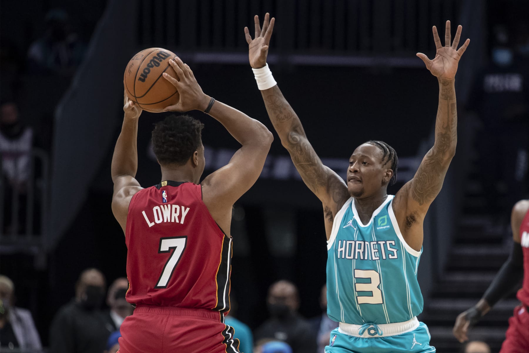 Charlotte Hornets guard Terry Rozier (3) defends against Miami Heat guard Kyle Lowry (7) during the first half of an NBA basketball game Thursday, Feb. 17, 2022, in Charlotte, N.C. (AP Photo/Matt Kelley)