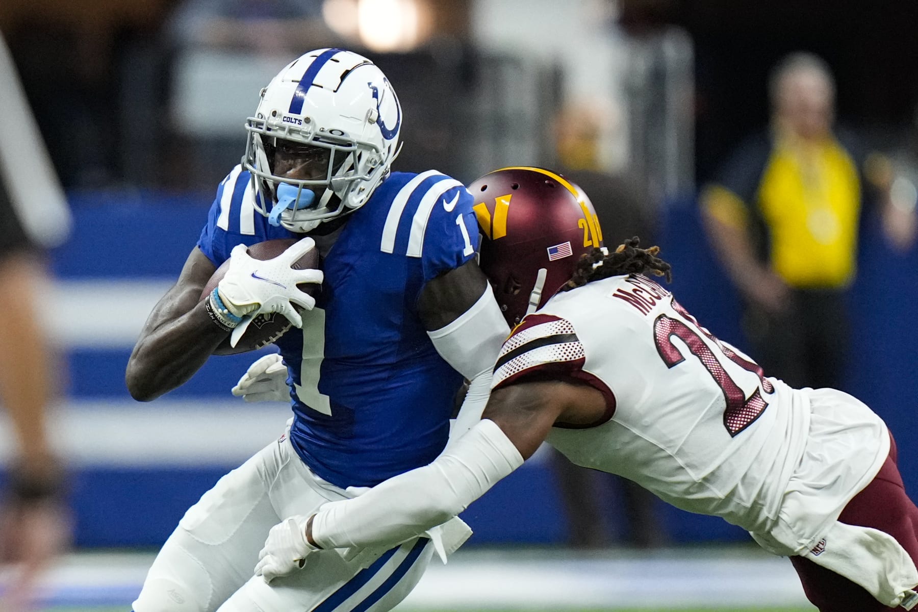 Indianapolis Colts running back Jonathan Taylor (28) breaks the tackle of Washington Commanders safety Bobby McCain (20) in the first half of an NFL football game in Indianapolis, Sunday, Oct. 30, 2022. (AP Photo/AJ Mast)