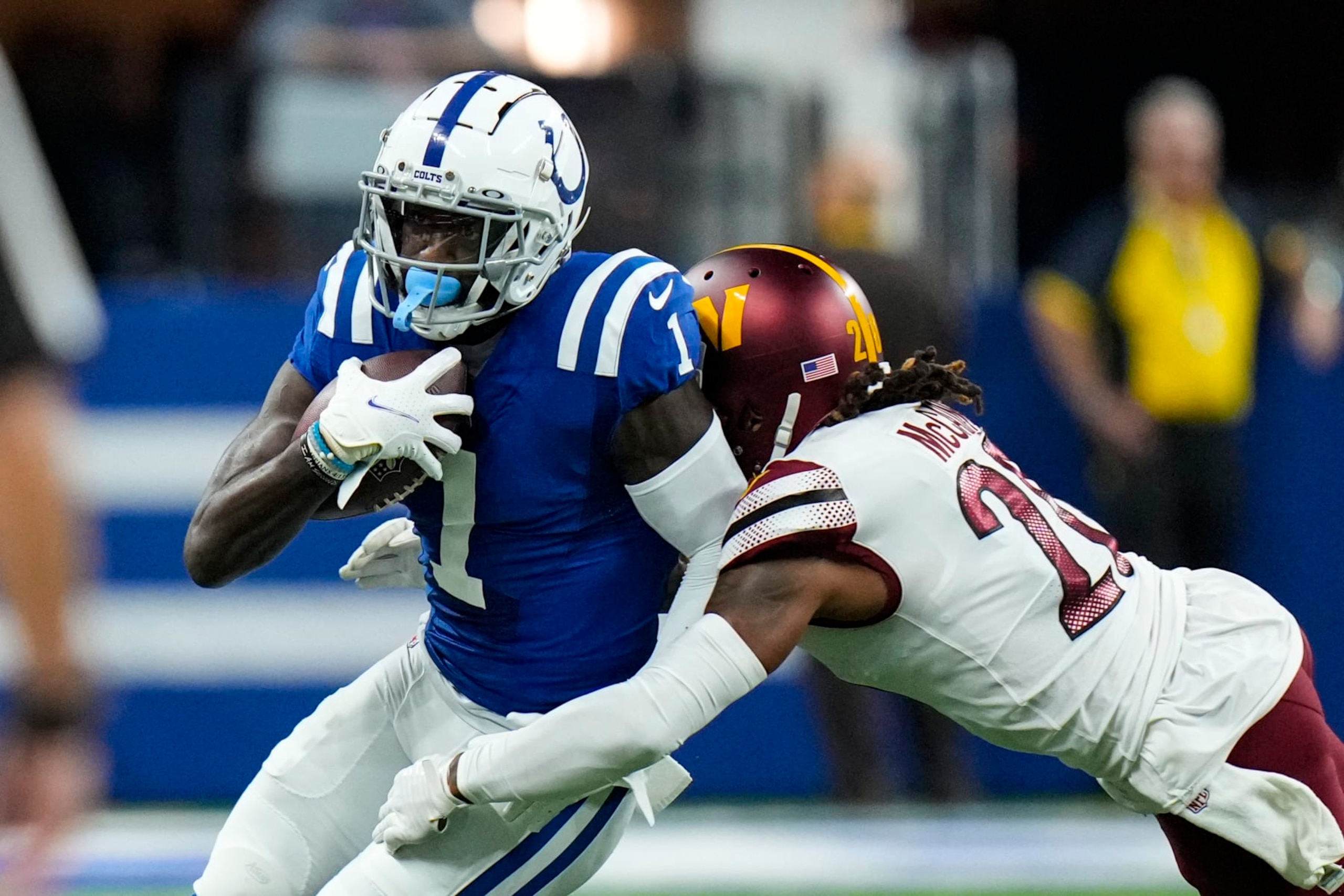 Indianapolis Colts running back Jonathan Taylor (28) breaks the tackle of Washington Commanders safety Bobby McCain (20) in the first half of an NFL football game in Indianapolis, Sunday, Oct. 30, 2022. (AP Photo/AJ Mast)