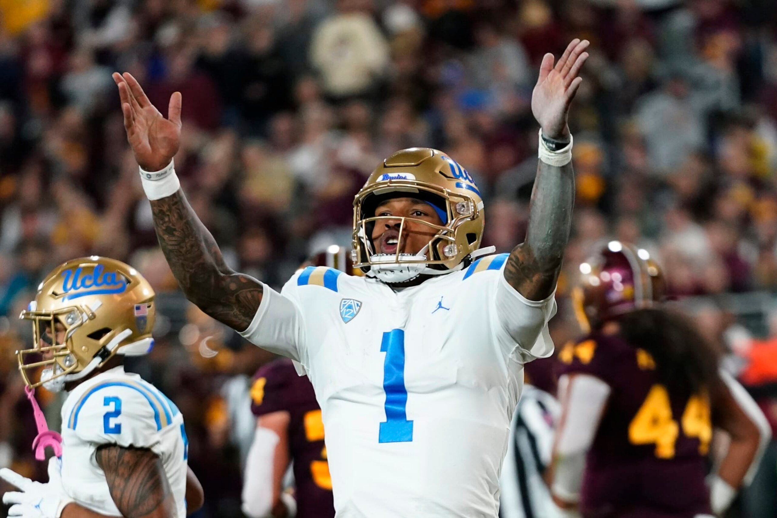 UCLA quarterback Dorian Thompson-Robinson celebrates his touchdown run against Arizona State during the first half of an NCAA college football game in Tempe, Ariz., Saturday, Nov. 5, 2022. (AP Photo/Ross D. Franklin)