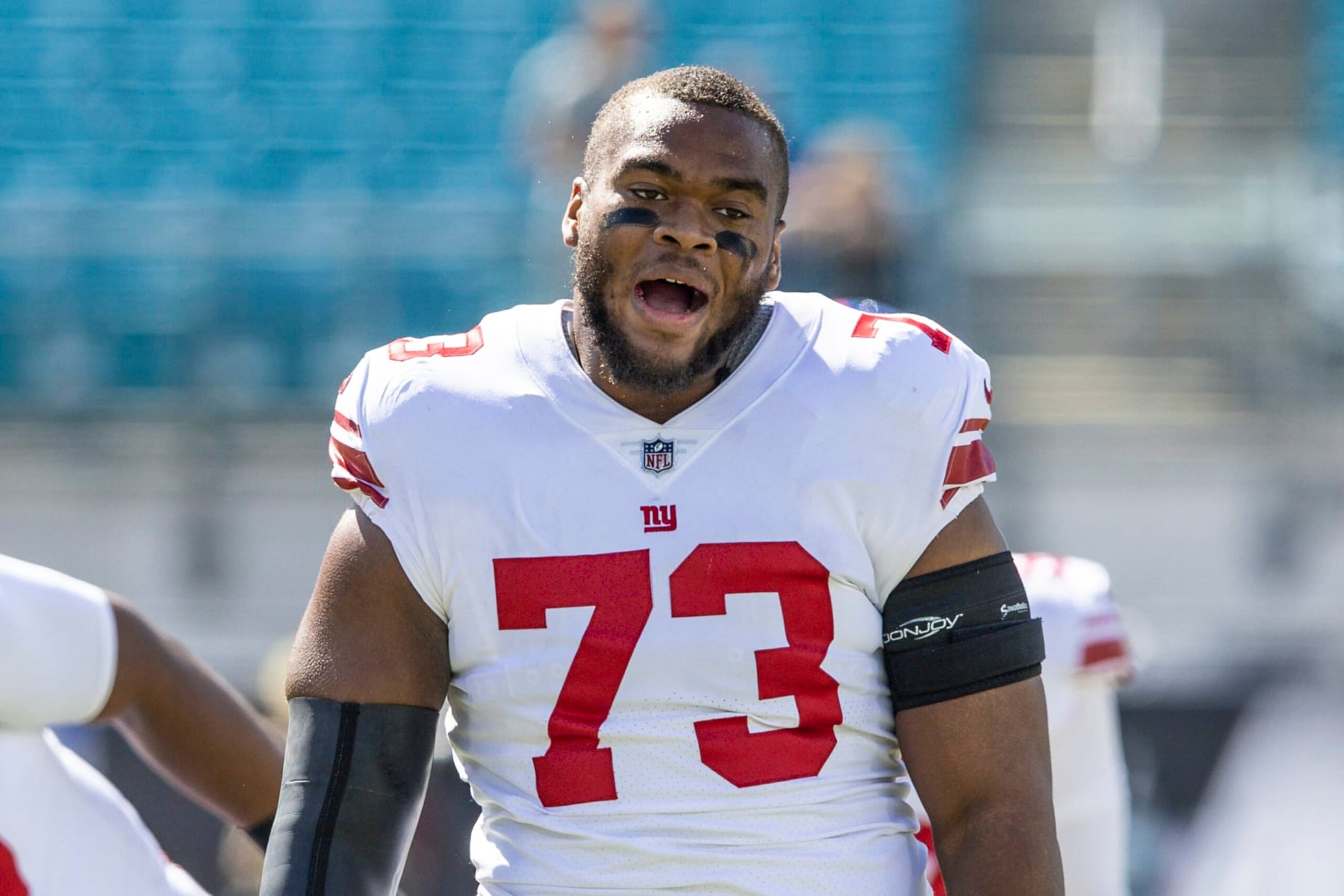 New York Giants offensive tackle Evan Neal (73) talks with a teammate during warm-ups before an NFL football game against the Jacksonville Jaguars on Sunday, Oct. 23, 2022, in Jacksonville, Fla. (AP Photo/Gary McCullough)