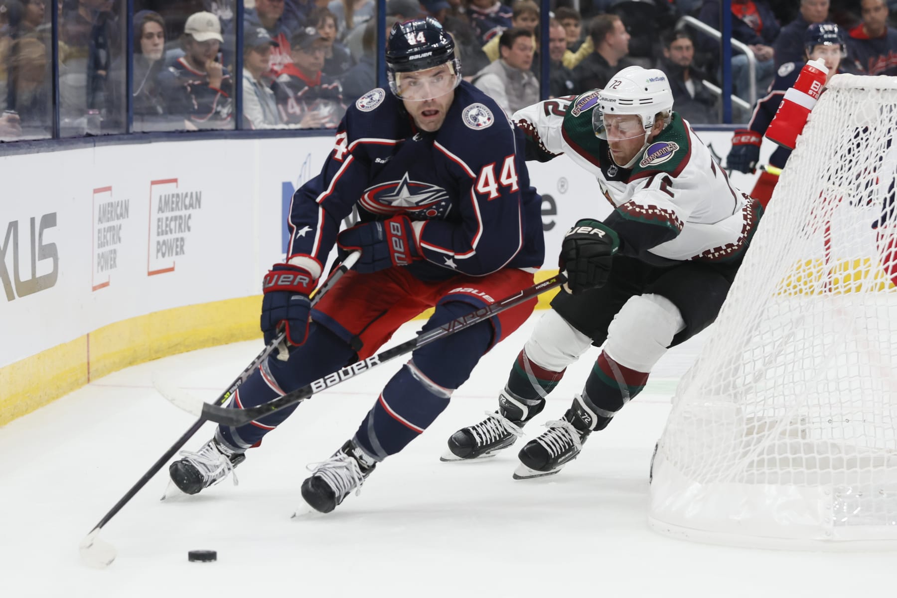Columbus Blue Jackets' Erik Gudbranson, left, looks for an open pass as Arizona Coyotes' Travis Boyd chases him during the first period of an NHL hockey game Tuesday, Oct. 25, 2022, in Columbus, Ohio. (AP Photo/Jay LaPrete)