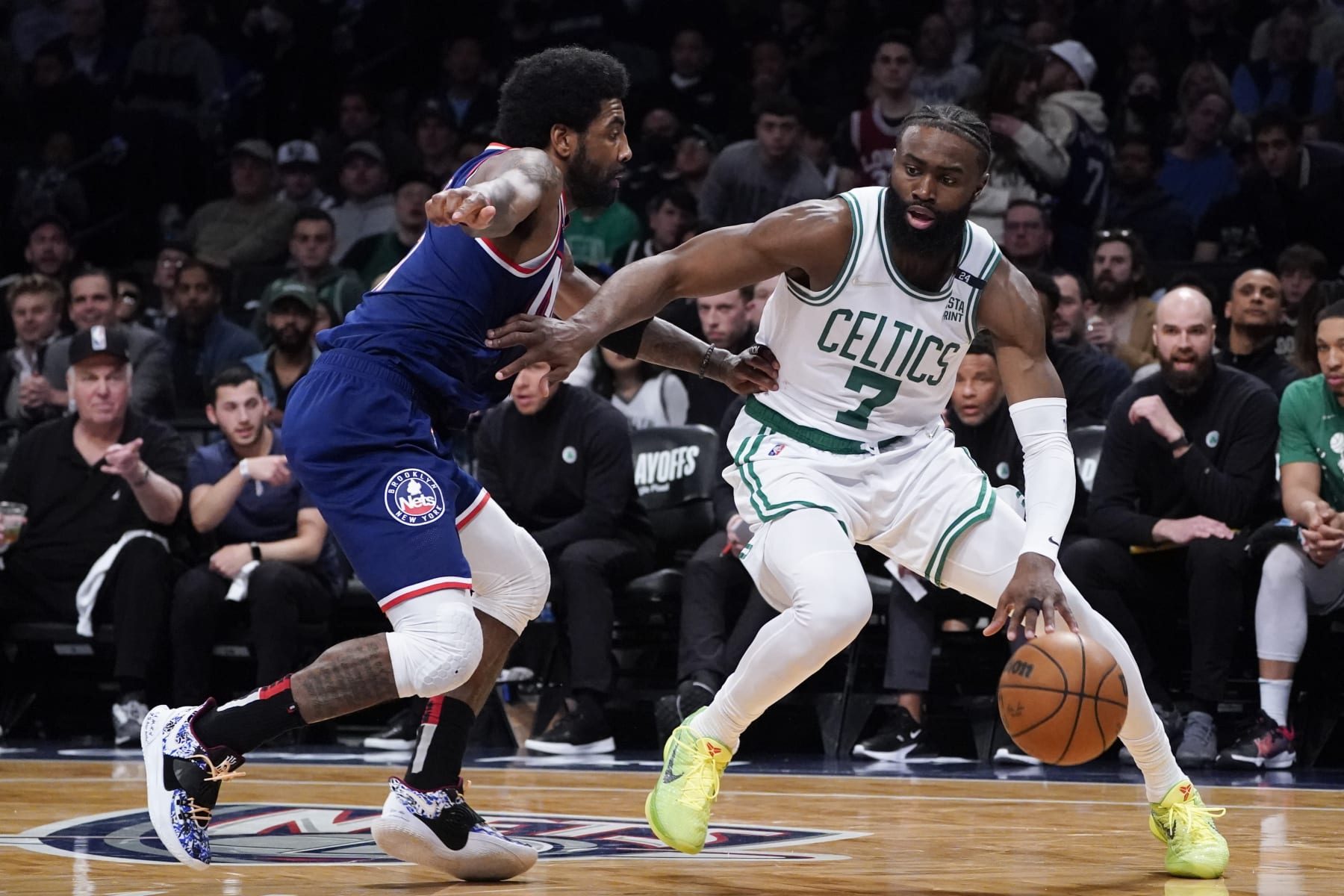 Boston Celtics guard Jaylen Brown (7) drives against Brooklyn Nets guard Kyrie Irving, left, during the second half of Game 4 of an NBA basketball first-round playoff series, Monday, April 25, 2022, in New York. (AP Photo/John Minchillo)