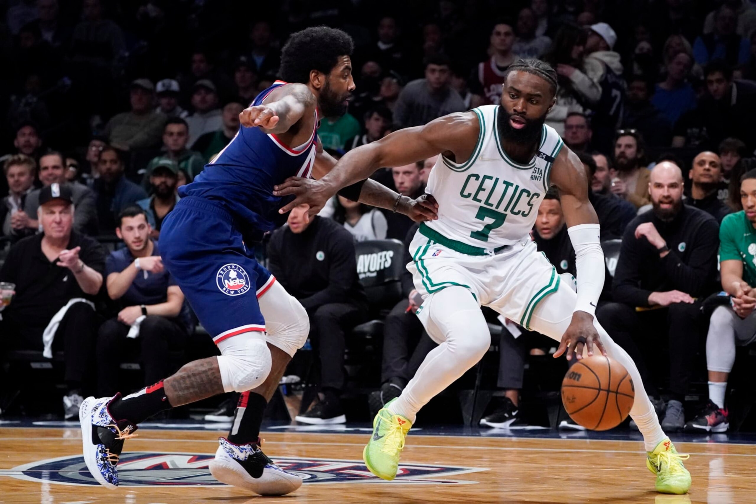 Boston Celtics guard Jaylen Brown (7) drives against Brooklyn Nets guard Kyrie Irving, left, during the second half of Game 4 of an NBA basketball first-round playoff series, Monday, April 25, 2022, in New York. (AP Photo/John Minchillo)