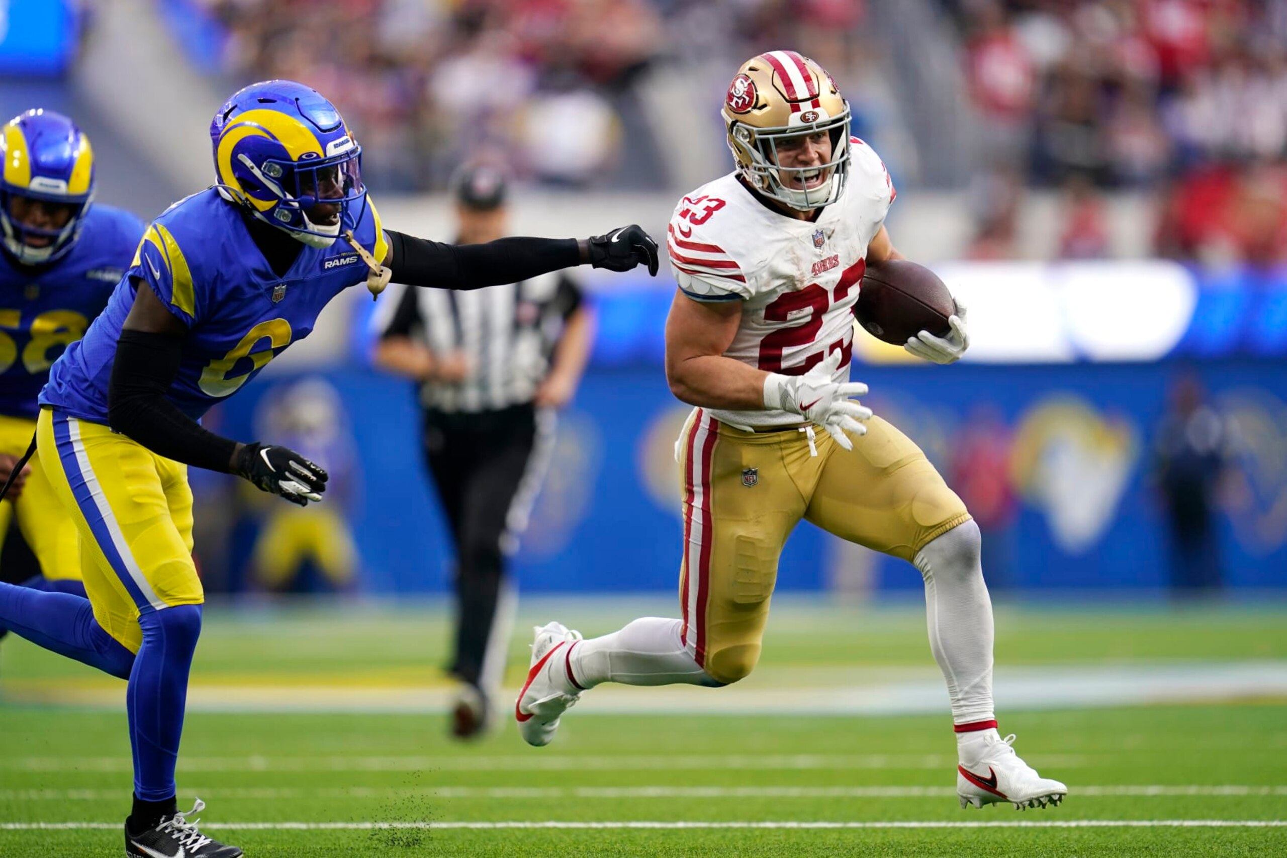San Francisco 49ers running back Christian McCaffrey, right, runs the ball as Los Angeles Rams cornerback Derion Kendrick gives chase during the second half of an NFL football game Sunday, Oct. 30, 2022, in Inglewood, Calif. (AP Photo/Ashley Landis) San Francisco 49ers running back Christian McCaffrey, right, runs the ball as Los Angeles Rams cornerback Derion Kendrick gives chase during the second half of an NFL football game Sunday, Oct. 30, 2022, in Inglewood, Calif. (AP Photo/Ashley Landis)