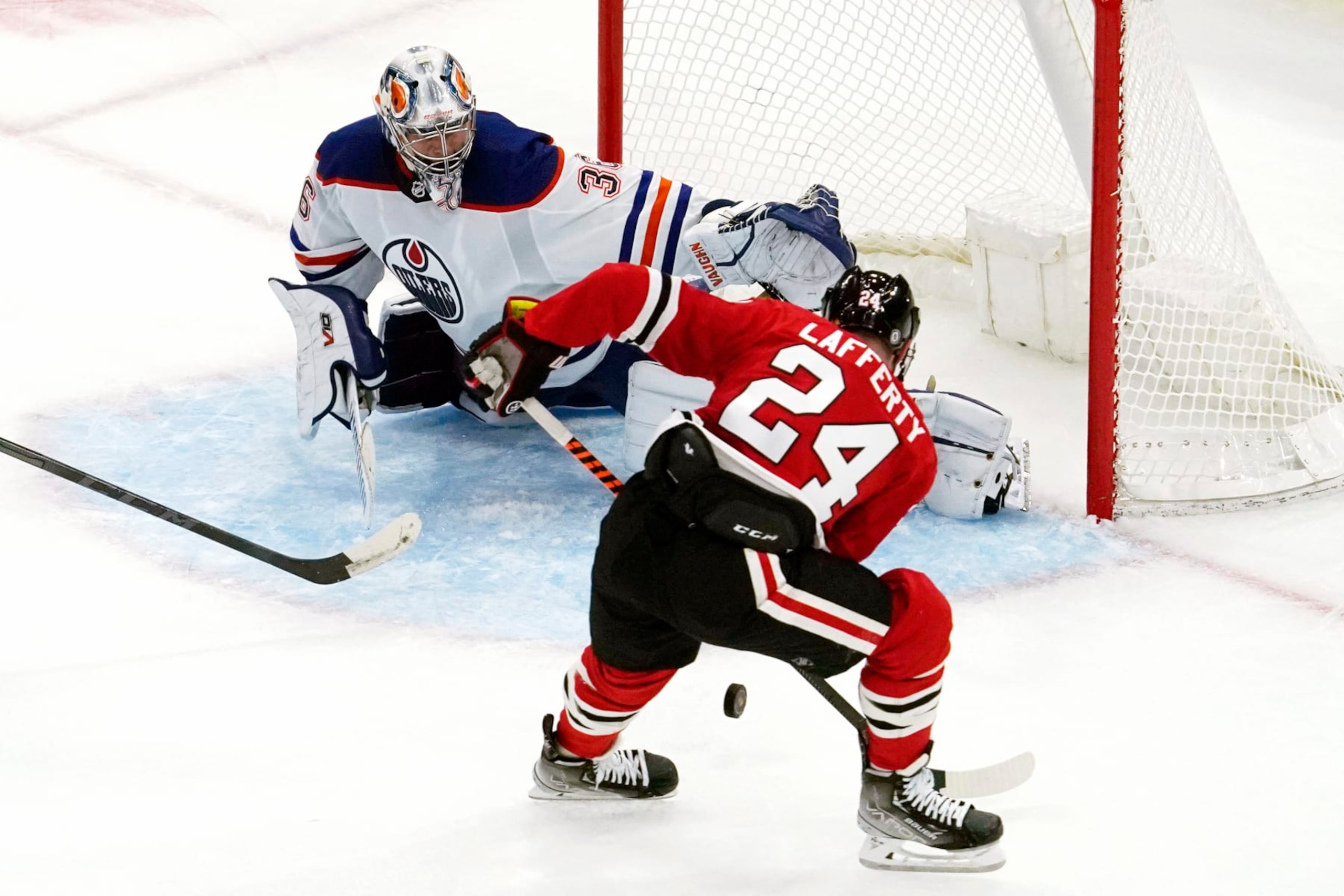 Edmonton Oilers goaltender Jack Campbell, left, tries to save a shot by Chicago Blackhawks center Sam Lafferty during the second period of an NHL hockey game in Chicago, Thursday, Oct. 27, 2022. (AP Photo/Nam Y. Huh) Edmonton Oilers goaltender Jack Campbell, left, tries to save a shot by Chicago Blackhawks center Sam Lafferty during the second period of an NHL hockey game in Chicago, Thursday, Oct. 27, 2022. (AP Photo/Nam Y. Huh)