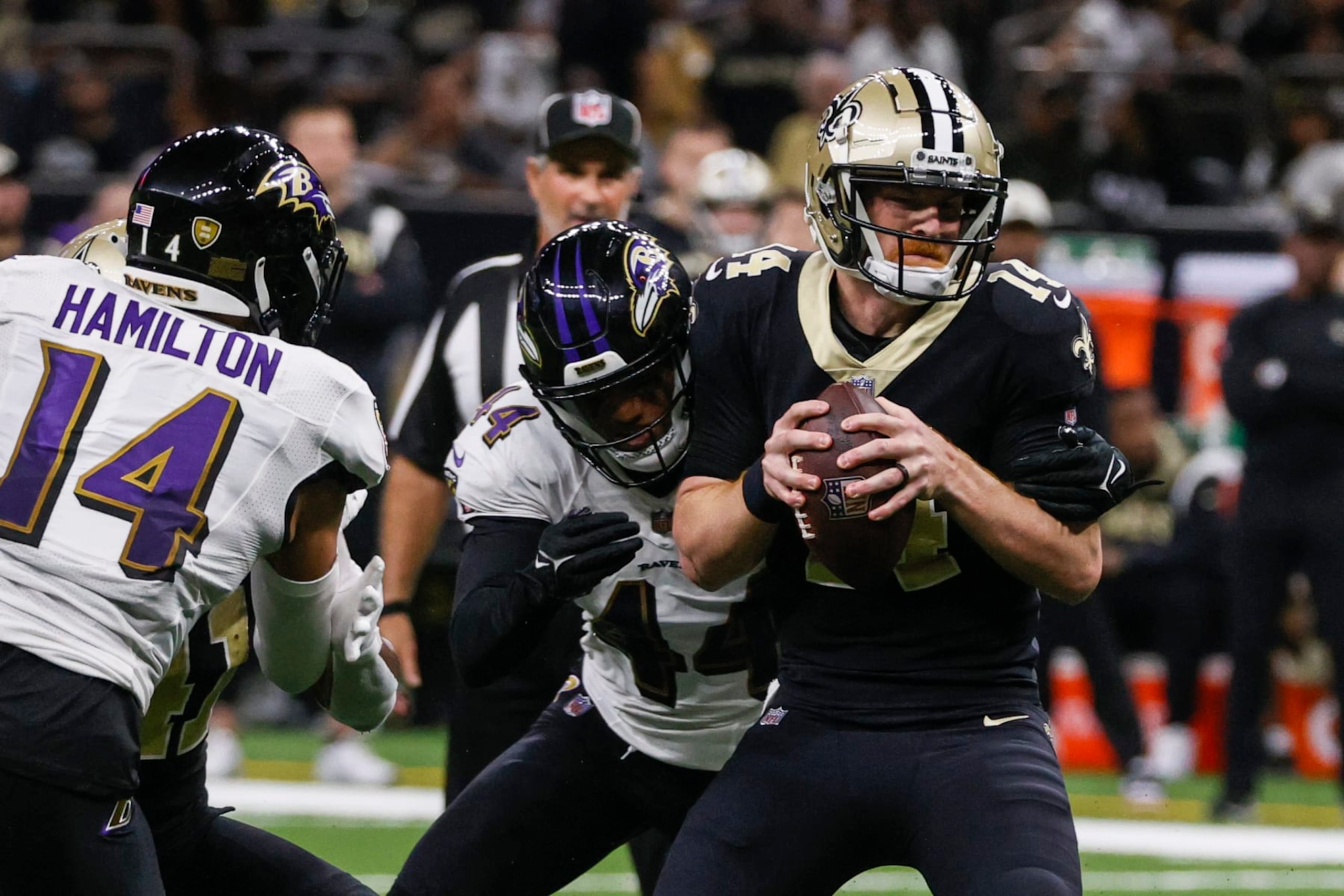 Baltimore Ravens cornerback Marlon Humphrey (44) is sacked New Orleans Saints quarterback Andy Dalton (14), with Baltimore Ravens safety Kyle Hamilton nearby in the second half of an NFL football game in New Orleans, Monday, Nov. 7, 2022. (AP Photo/Butch Dill)