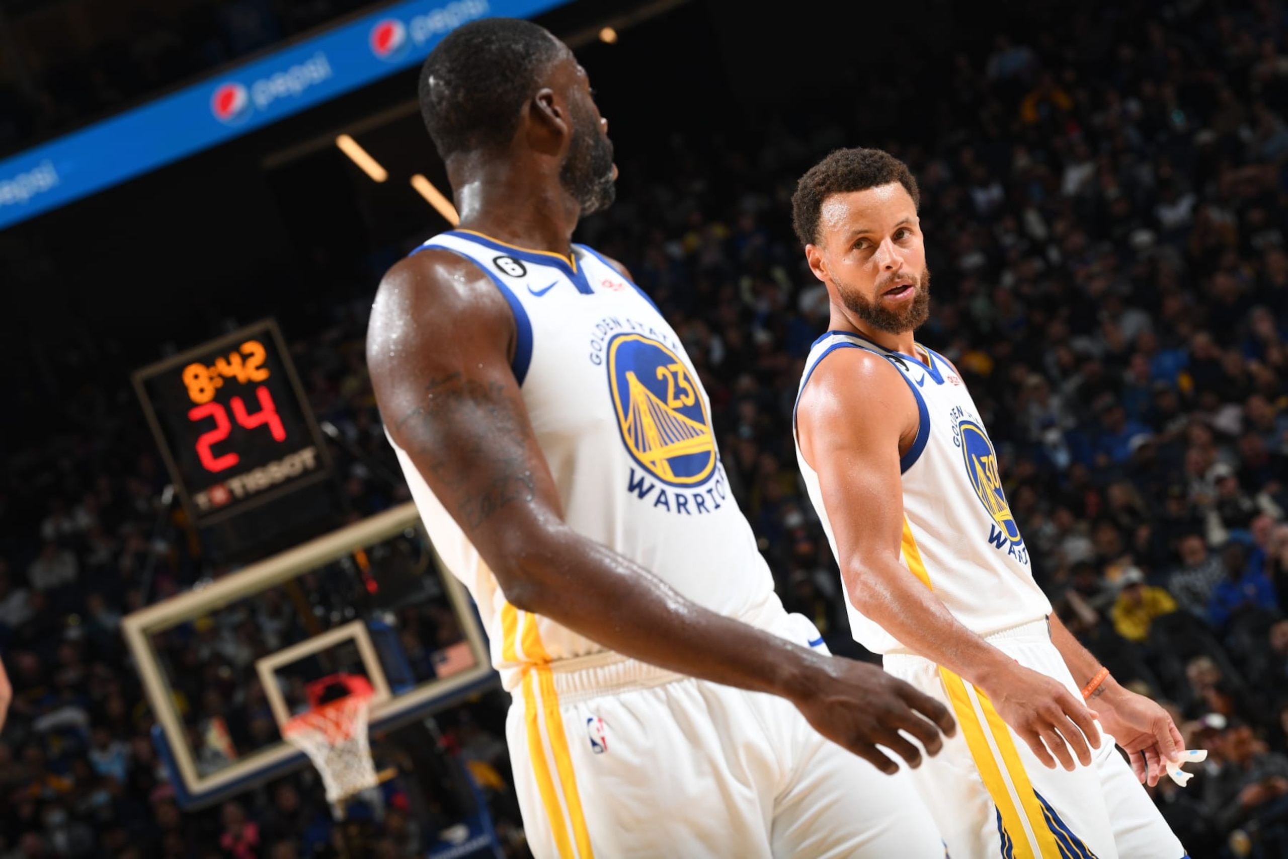 SAN FRANCISCO, CA - OCTOBER 27: Stephen Curry #30 of the Golden State Warriors and Draymond Green #23 look on during the game against the Miami Heat on October 27, 2022 at Chase Center in San Francisco, California. NOTE TO USER: User expressly acknowledges and agrees that, by downloading and or using this photograph, user is consenting to the terms and conditions of Getty Images License Agreement. Mandatory Copyright Notice: Copyright 2022 NBAE (Photo by Noah Graham/NBAE via Getty Images)