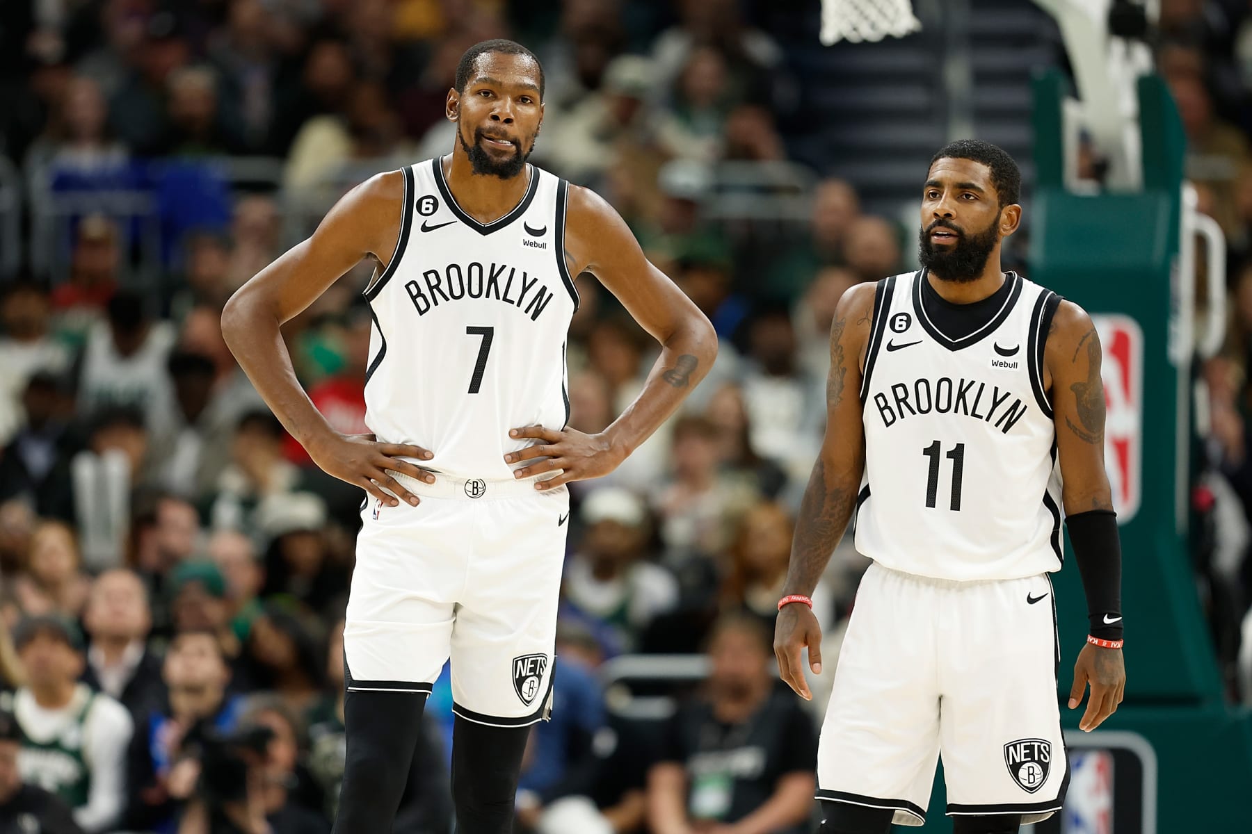 MILWAUKEE, WISCONSIN - OCTOBER 26: Kevin Durant #7 and Kyrie Irving #11 of the Brooklyn Nets talk during the second half of the game against the Milwaukee Bucks at Fiserv Forum on October 26, 2022 in Milwaukee, Wisconsin. NOTE TO USER: User expressly acknowledges and agrees that, by downloading and or using this photograph, User is consenting to the terms and conditions of the Getty Images License Agreement. (Photo by John Fisher/Getty Images)