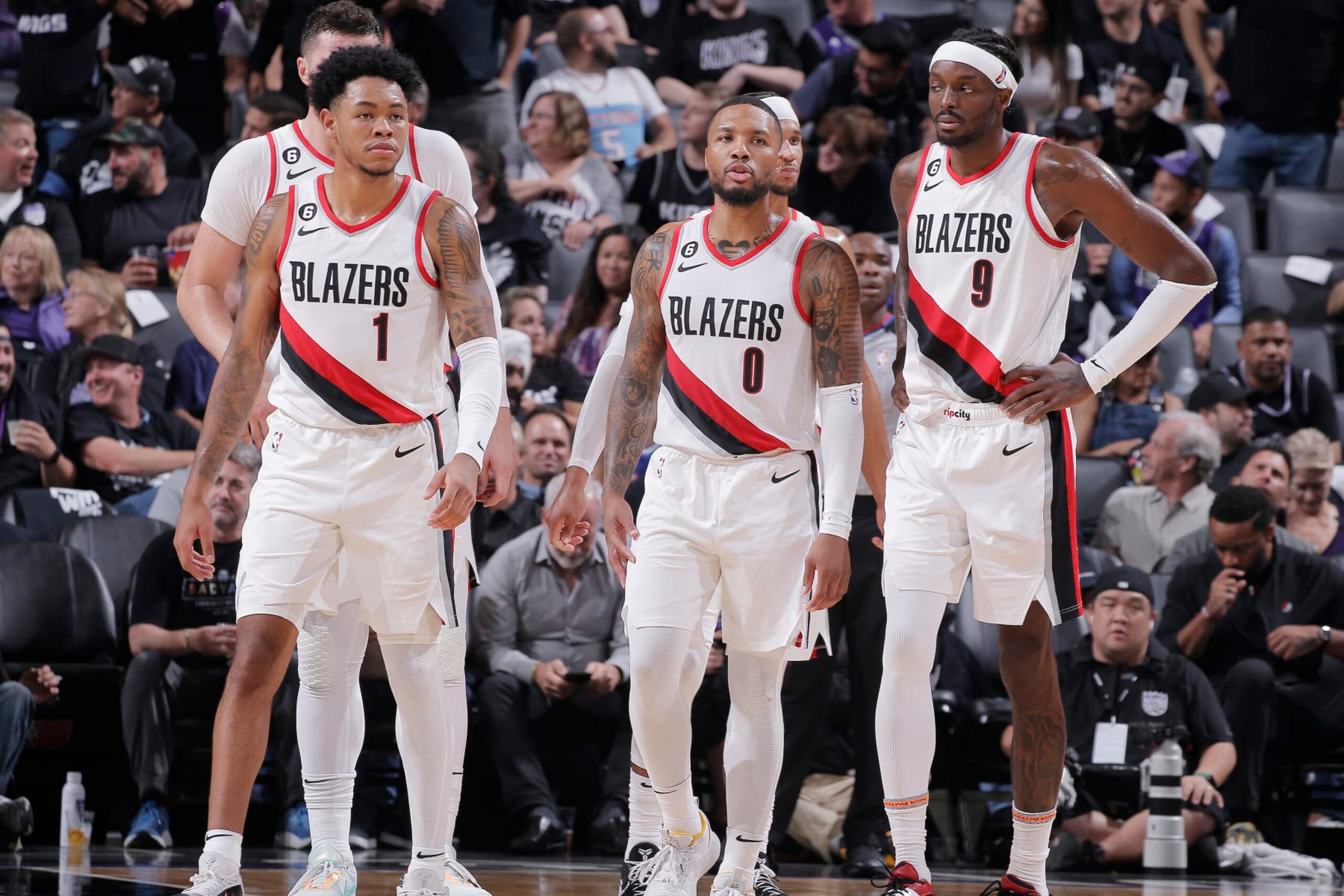 SACRAMENTO, CA - OCTOBER 19: Anfernee Simons #1, Damian Lillard #0, and Jerami Grant #9 of the Portland Trail Blazers look on during the game against the Sacramento Kings on October 19, 2022 at Golden 1 Center in Sacramento, California. NOTE TO USER: User expressly acknowledges and agrees that, by downloading and or using this photograph, User is consenting to the terms and conditions of the Getty Images Agreement. Mandatory Copyright Notice: Copyright 2022 NBAE (Photo by Rocky Widner/NBAE via Getty Images)
