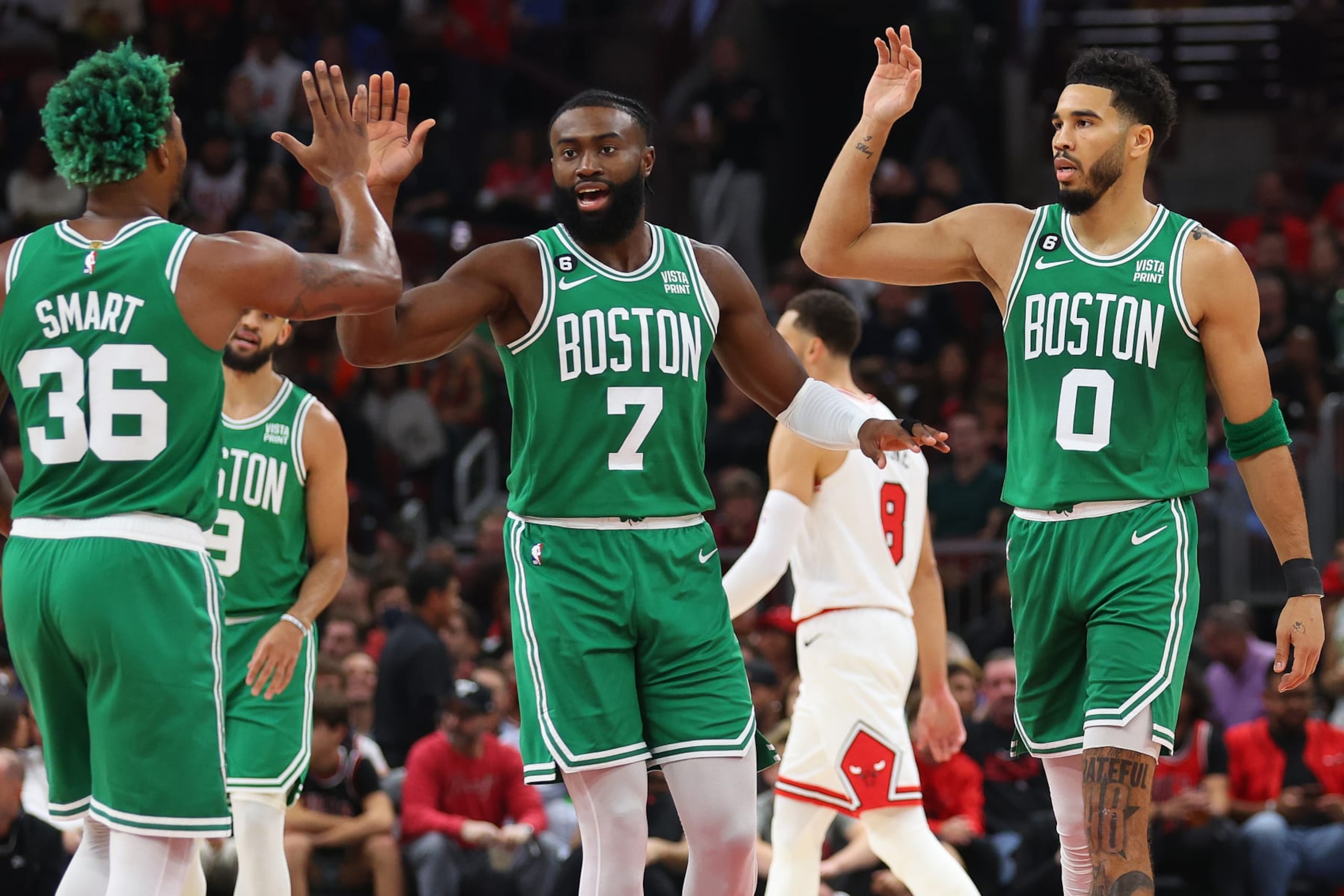 CHICAGO, ILLINOIS - OCTOBER 24: Marcus Smart #36, Jaylen Brown #7 and Jayson Tatum #0 of the Boston Celtics celebrate against the Chicago Bulls during the first half at United Center on October 24, 2022 in Chicago, Illinois. NOTE TO USER: User expressly acknowledges and agrees that, by downloading and or using this photograph, User is consenting to the terms and conditions of the Getty Images License Agreement. (Photo by Michael Reaves/Getty Images)
