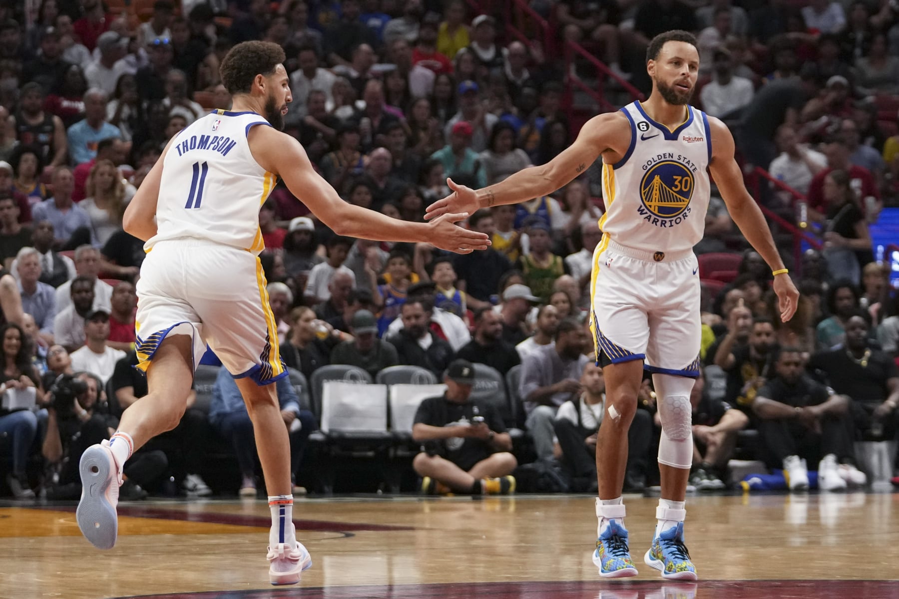 MIAMI, FL - NOVEMBER 01: Stephen Curry #30 of the Golden State Warriors congratulates Klay Thompson #11 after making a three-point shot during the second half against the Miami HEAT at FTX Arena on November 1, 2022 in Miami, Florida. NOTE TO USER: User expressly acknowledges and agrees that,  by downloading and or using this photograph,  User is consenting to the terms and conditions of the Getty Images License Agreement.(Photo by Eric Espada/Getty Images)