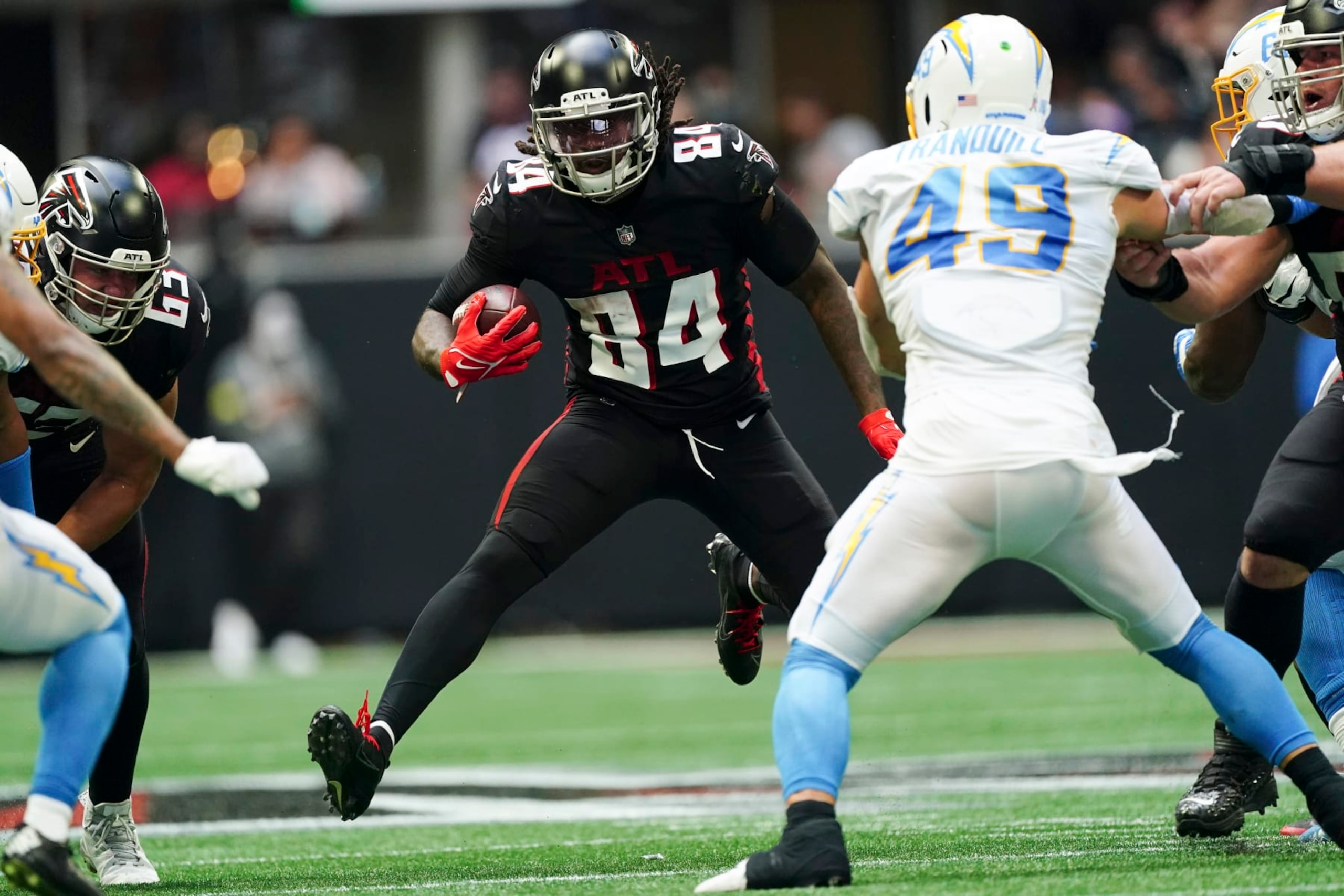 Atlanta Falcons running back Cordarrelle Patterson (84) runs from Los Angeles Chargers linebacker Drue Tranquill (49) during the second half of an NFL football game, Sunday, Nov. 6, 2022, in Atlanta. (AP Photo/John Bazemore)