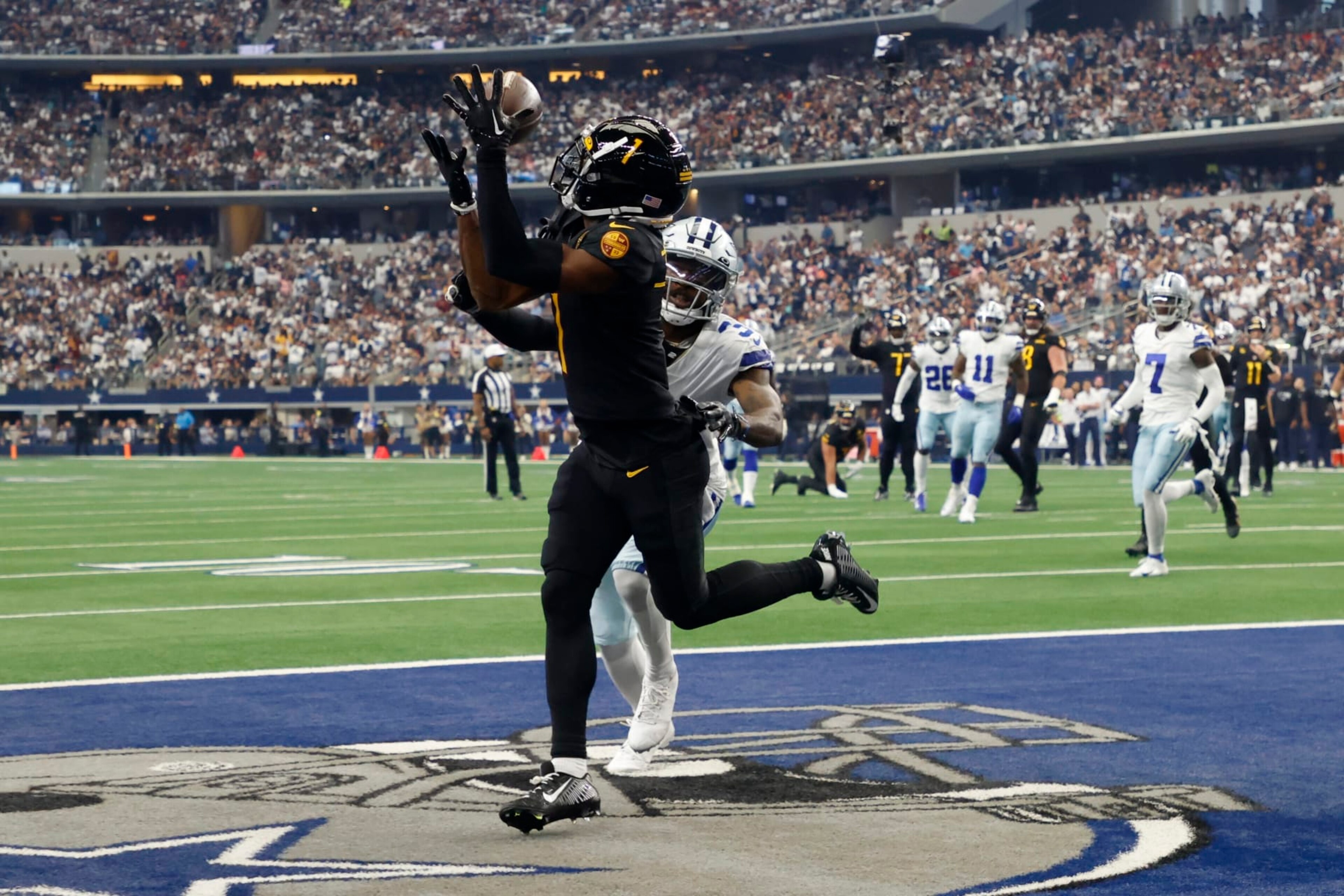 Washington Commanders wide receiver Jahan Dotson (1) reaches up to catch a touchdown pass in front of Dallas Cowboys cornerback Anthony Brown, rear, in the first half of a NFL football game in Arlington, Texas, Sunday, Oct. 2, 2022. (AP Photo/Michael Ainsworth)