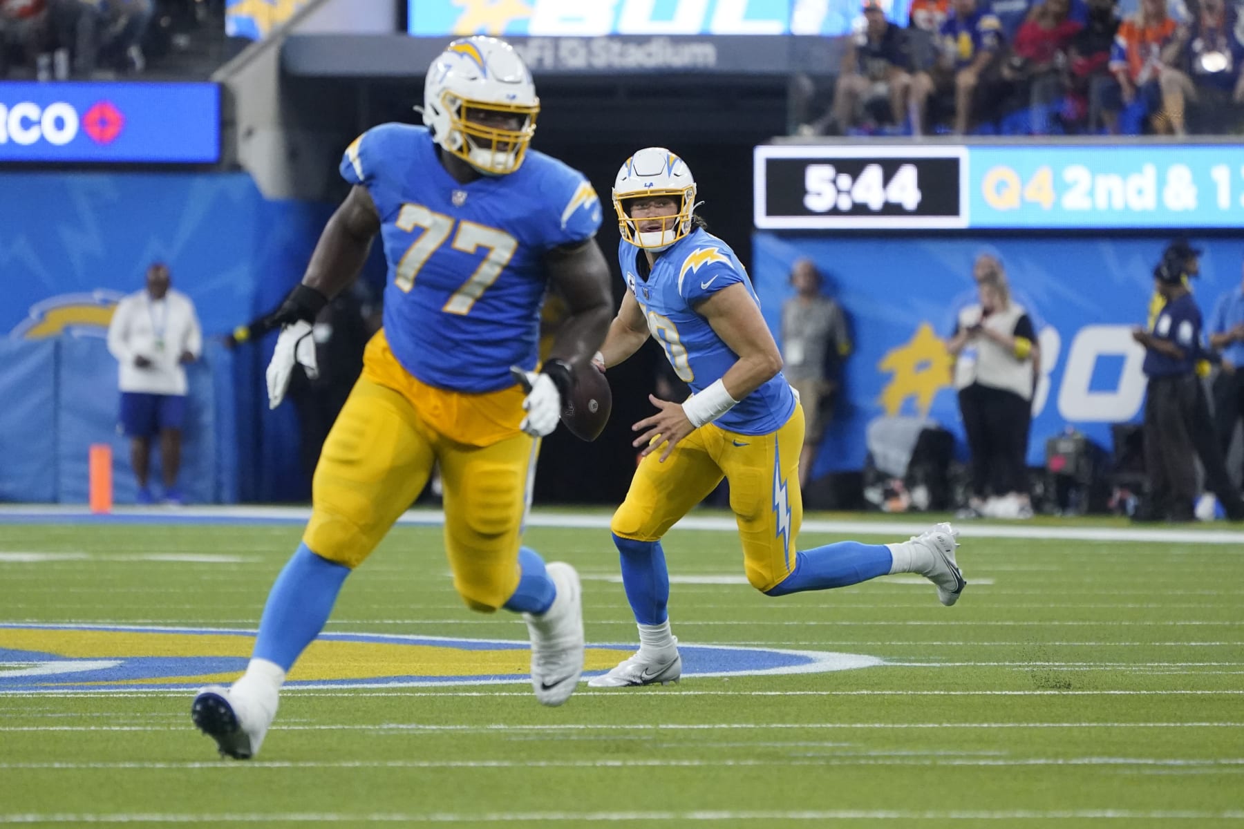 Los Angeles Chargers guard Zion Johnson (77) blocks for quarterback Justin Herbert (10) during the second half of an NFL football game against the Denver Broncos Monday, Oct. 17, 2022, in Inglewood. (AP Photo/Marcio Jose Sanchez)