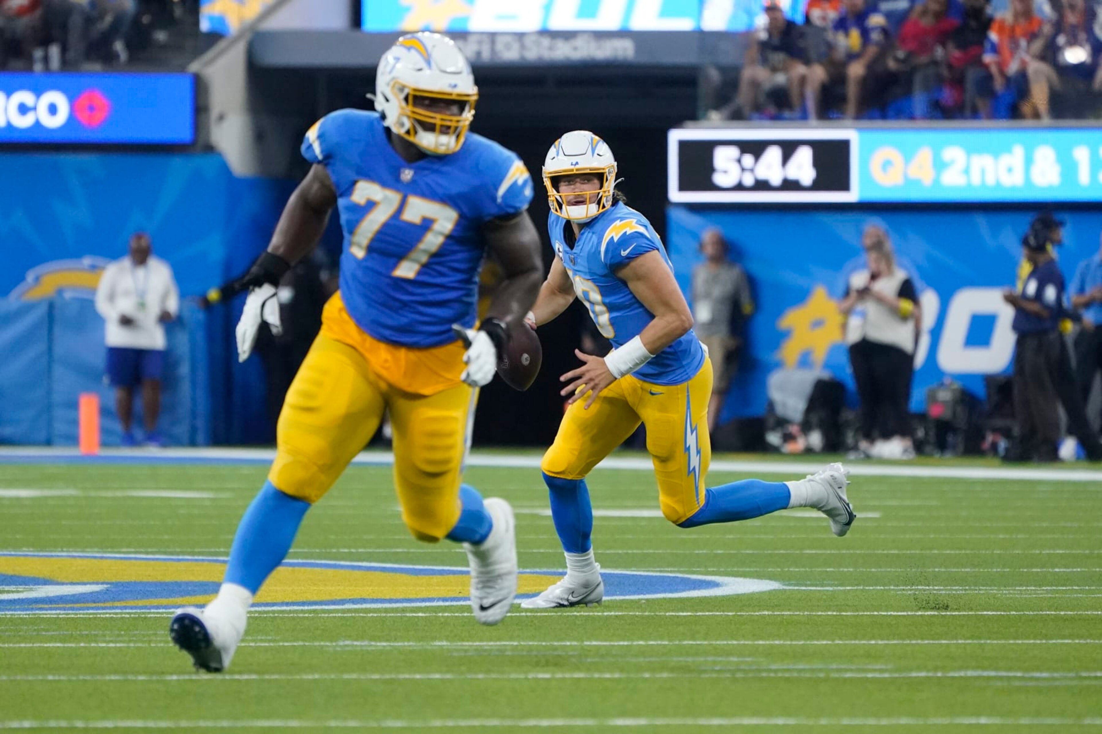 Los Angeles Chargers guard Zion Johnson (77) blocks for quarterback Justin Herbert (10) during the second half of an NFL football game against the Denver Broncos Monday, Oct. 17, 2022, in Inglewood. (AP Photo/Marcio Jose Sanchez)