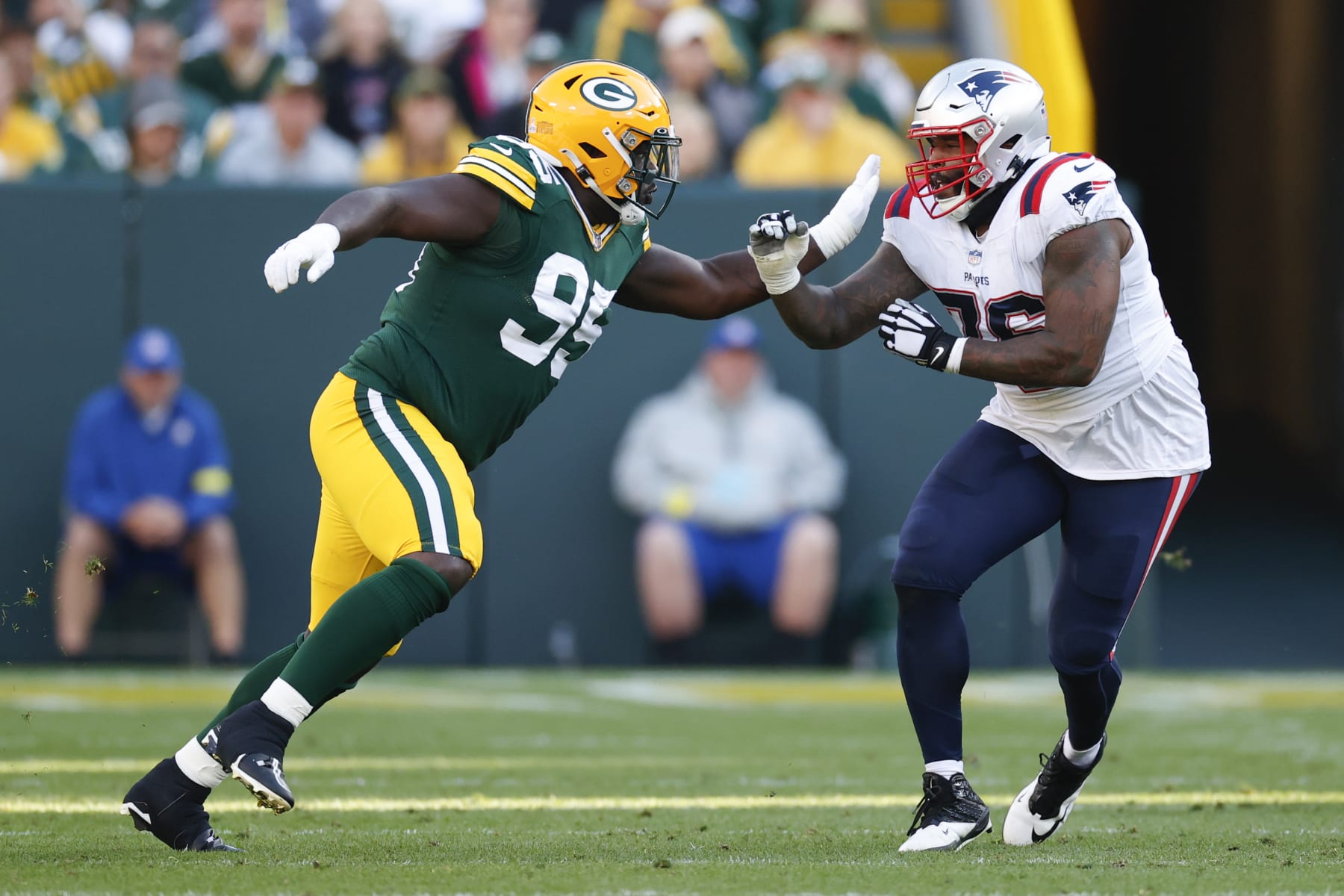 Green Bay Packers defensive tackle Devonte Wyatt (95) battles for the position with New England Patriots offensive tackle Isaiah Wynn (76) during the first half of an NFL football game, Sunday, Oct. 2, 2022, in Green Bay, Wis. (AP Photo/Kamil Krzaczynski)