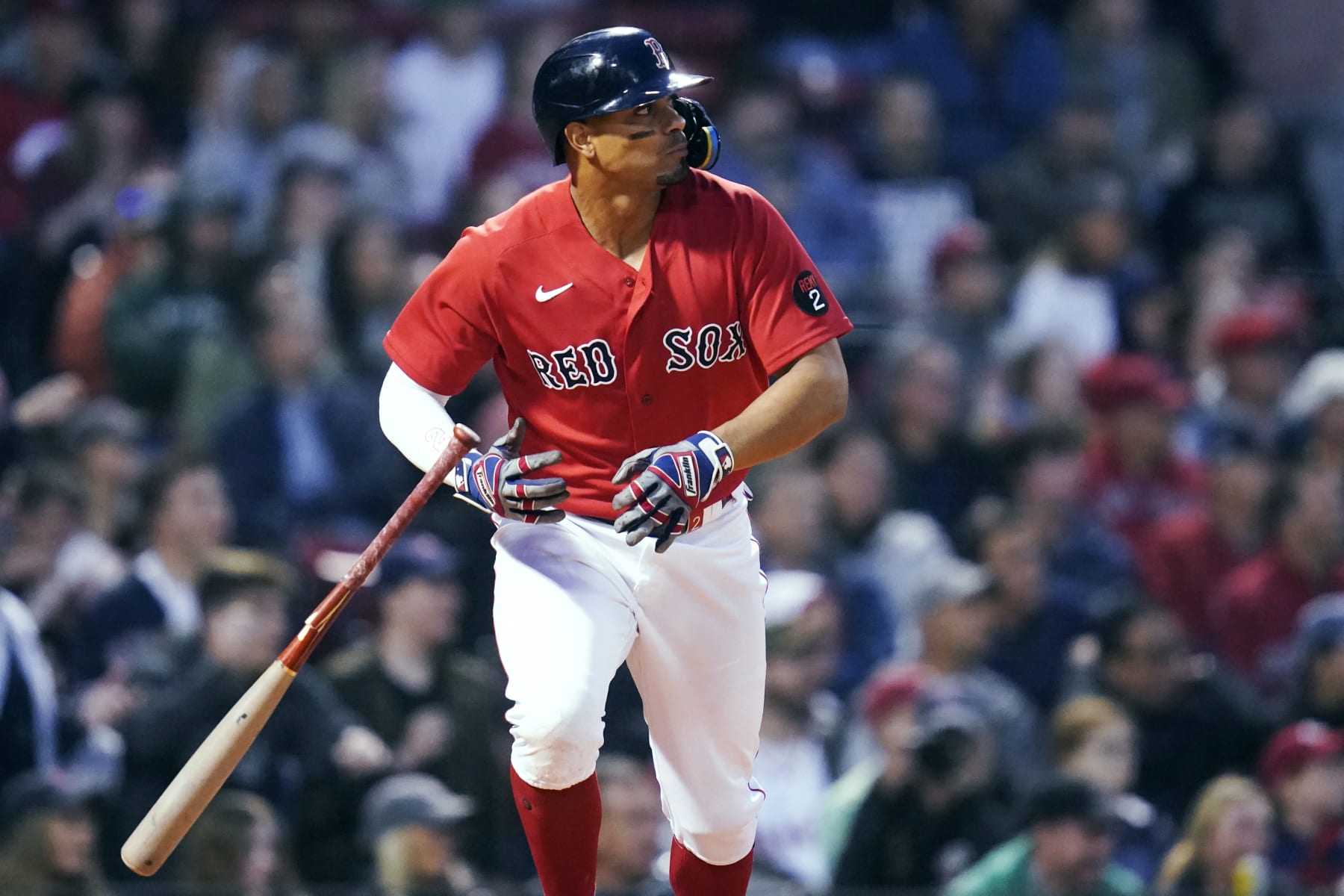 Boston Red Sox's Xander Bogaerts tosses his bat after hitting an RBI single against the Cincinnati Reds during the fourth inning of a baseball game Wednesday, June 1, 2022, at Fenway Park in Boston. (AP Photo/Charles Krupa)