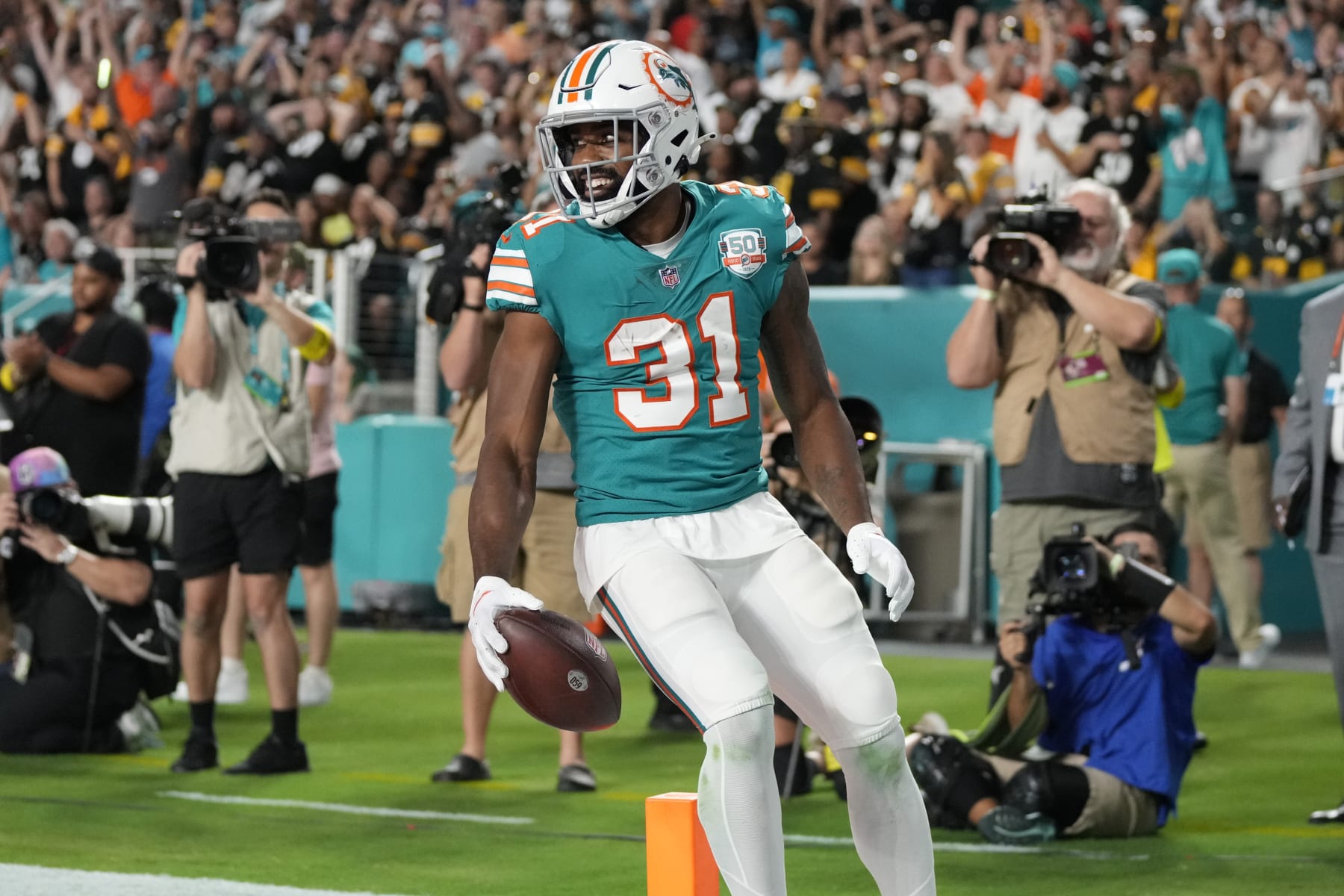 Miami Dolphins running back Raheem Mostert (31) scores a touchdown during the first half of an NFL football game against the Pittsburgh Steelers, Sunday, Oct. 23, 2022, in Miami Gardens, Fla. (AP Photo/Rebecca Blackwell)