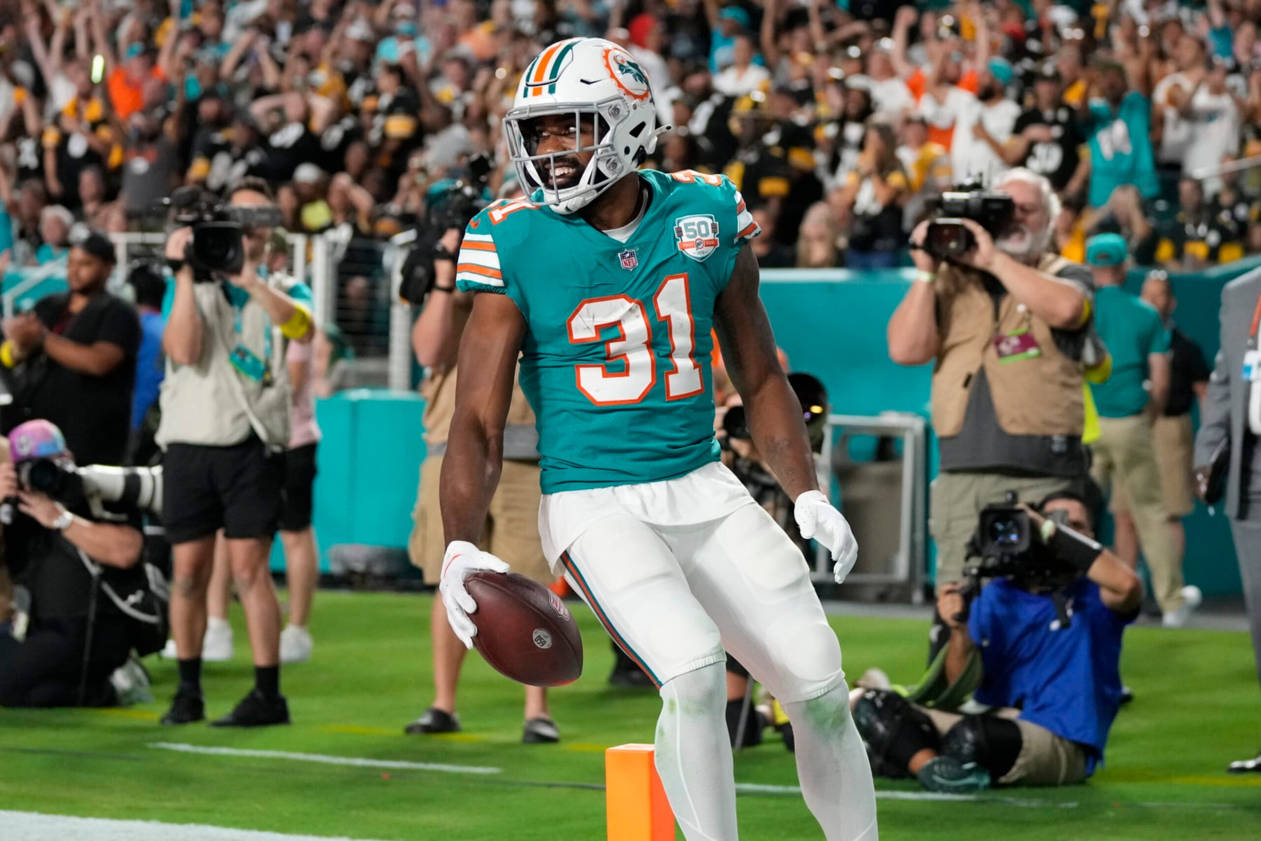 Miami Dolphins running back Raheem Mostert (31) scores a touchdown during the first half of an NFL football game against the Pittsburgh Steelers, Sunday, Oct. 23, 2022, in Miami Gardens, Fla. (AP Photo/Rebecca Blackwell)
