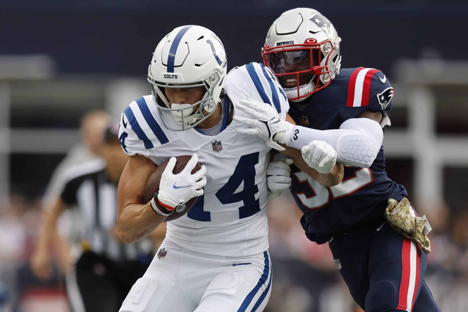 Indianapolis Colts wide receiver Alec Pierce (14) is pushed out of bounds by New England Patriots safety Devin McCourty (32) in the first half of an NFL football game, Sunday, Nov. 6, 2022, in Foxborough, Mass. (AP Photo/Michael Dwyer)