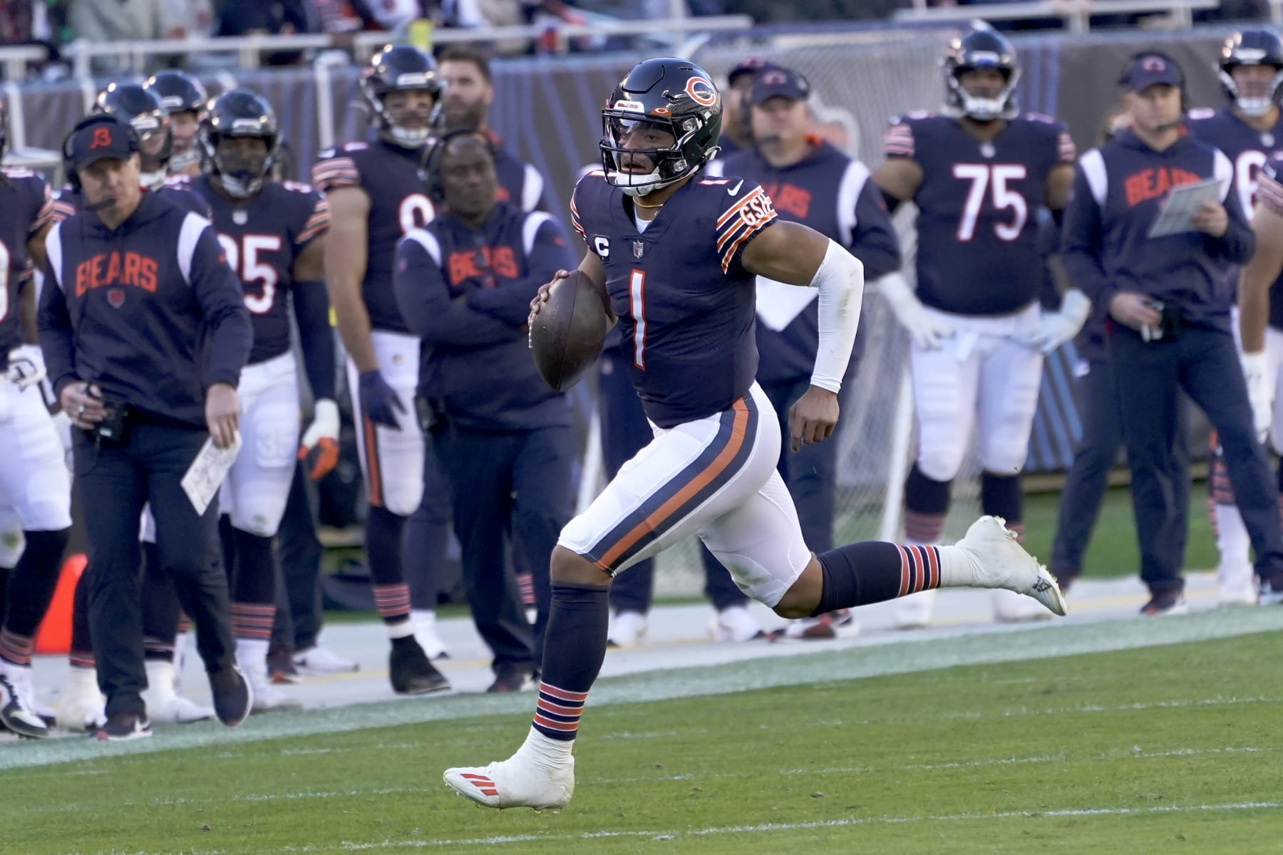 Chicago Bears quarterback Justin Fields carries the ball during an NFL football game against the Miami Dolphins Sunday, Nov. 6, 2022, in Chicago. (AP Photo/Charles Rex Arbogast)
