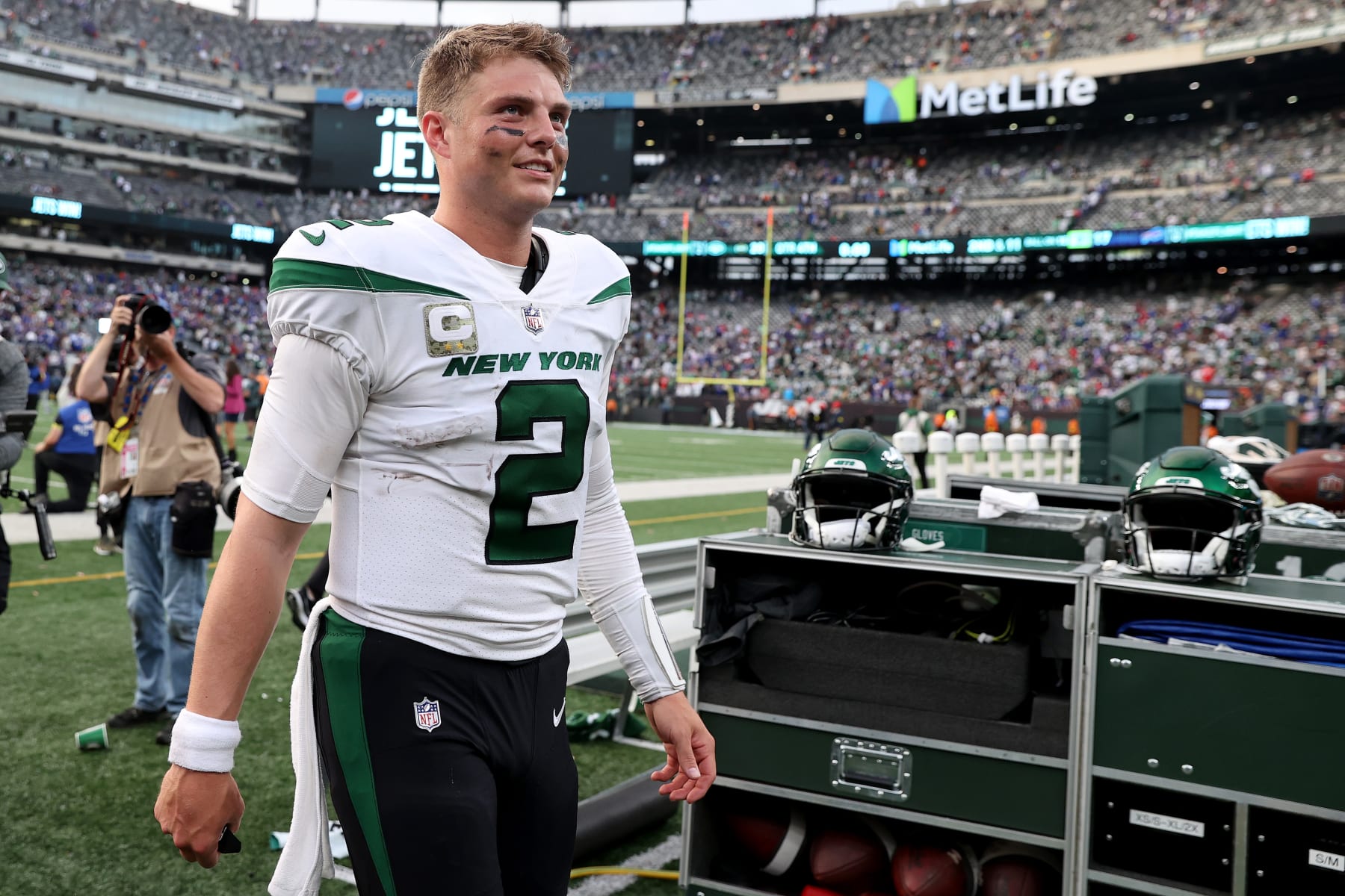 EAST RUTHERFORD, NEW JERSEY - NOVEMBER 06: Zach Wilson #2 of the New York Jets looks on and smiles after beating the Buffalo Bills 20-17 at MetLife Stadium on November 06, 2022 in East Rutherford, New Jersey. (Photo by Elsa/Getty Images)