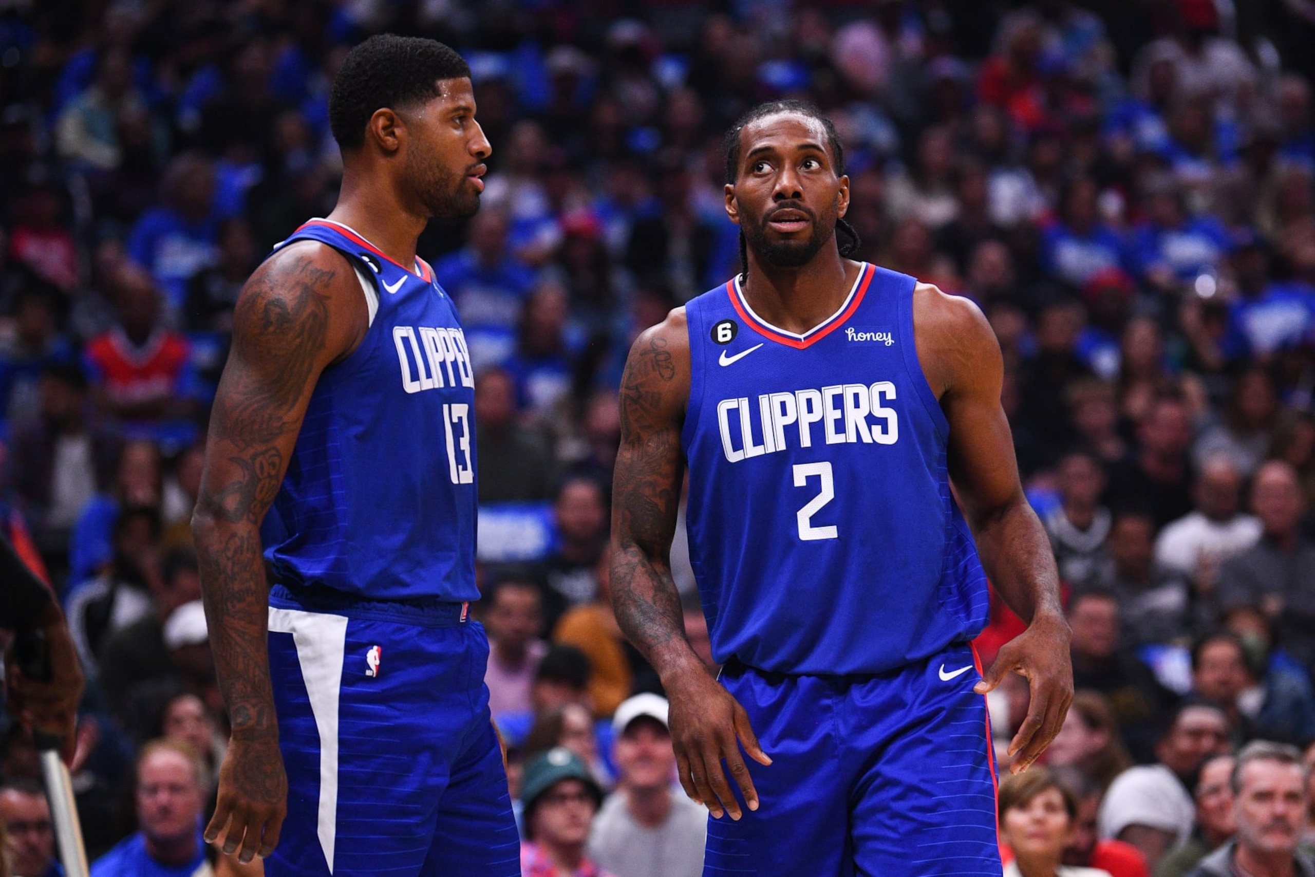 LOS ANGELES, CA - OCTOBER 23: Los Angeles Clippers forward Paul George (13) looks on with Los Angeles Clippers forward Kawhi Leonard (2) during a NBA game between the Phoenix Suns and the Los Angeles Clippers on October 23, 2022 at Crypto.com Arena in Los Angeles, CA. (Photo by Brian Rothmuller/Icon Sportswire via Getty Images)