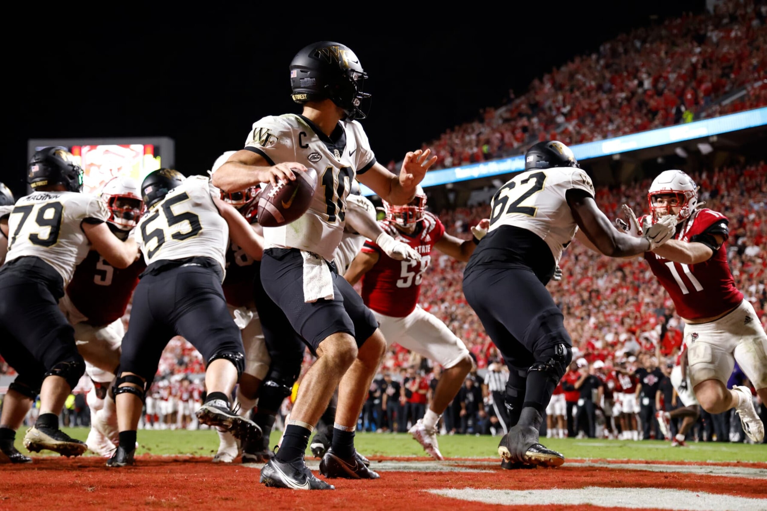 RALEIGH, NC - NOVEMBER 05: Sam Hartman #10 of the Wake Forest Demon Deacons drops back to pass during the second half of their game against the North Carolina State Wolfpack at Carter-Finley Stadium on November 5, 2022 in Raleigh, North Carolina. NC State won 30-21. (Photo by Lance King/Getty Images) RALEIGH, NC - NOVEMBER 05: Sam Hartman #10 of the Wake Forest Demon Deacons drops back to pass during the second half of their game against the North Carolina State Wolfpack at Carter-Finley Stadium on November 5, 2022 in Raleigh, North Carolina. NC State won 30-21. (Photo by Lance King/Getty Images)